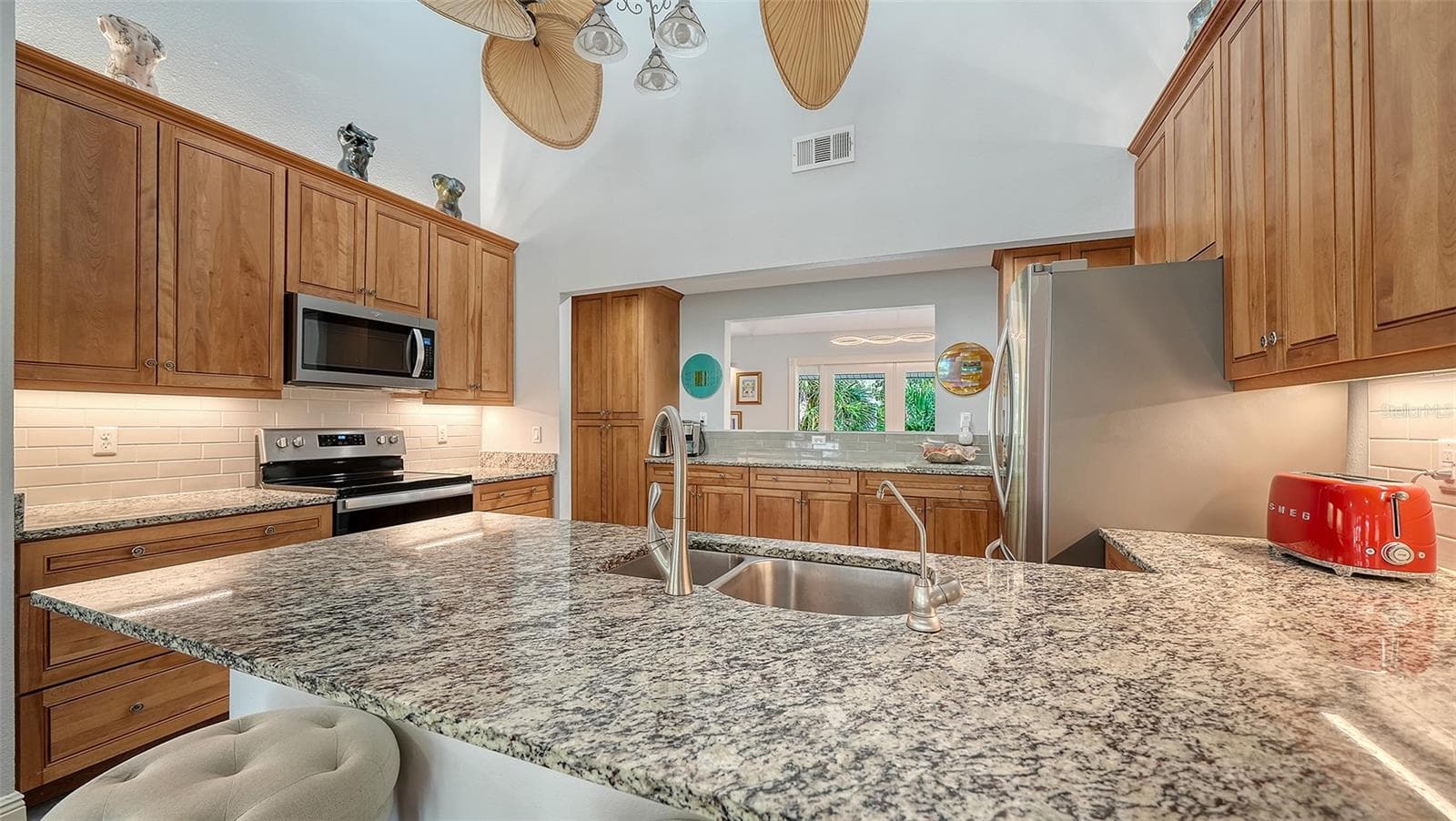 Remodeled kitchen with granite countertops, custom cabinetry and stainless steel appliances. - SARASOTA