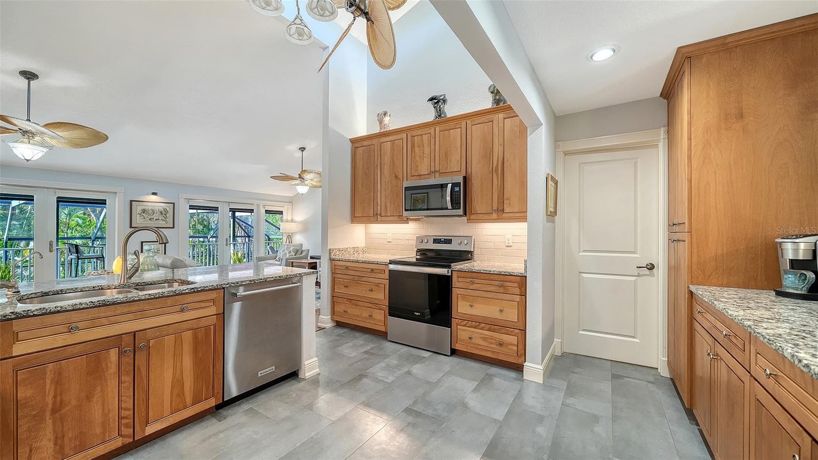 Additional view of the remodeled kitchen with abundant cabinetry and workspace. - SARASOTA