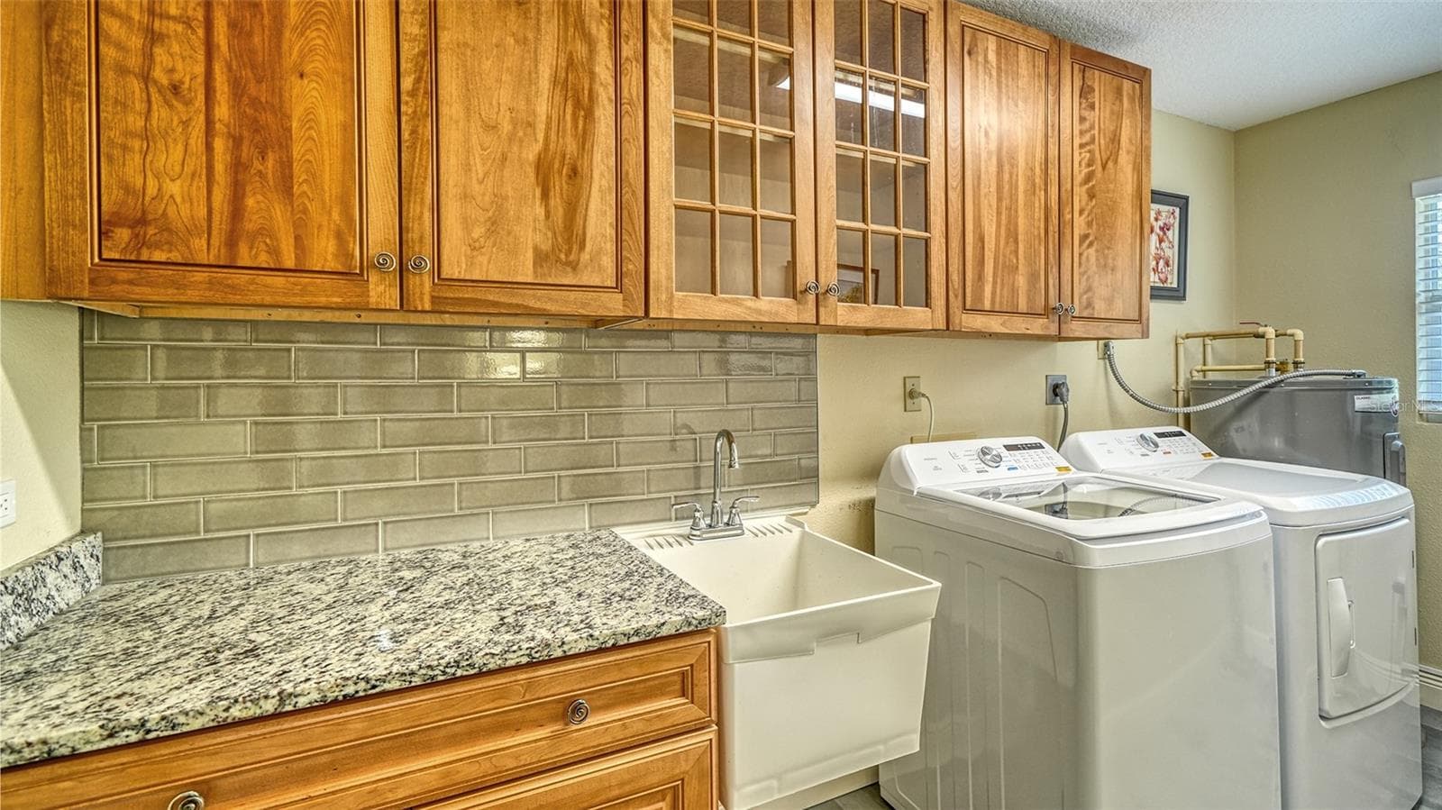Convenient laundry room with cabinetry and new washer and dryer. - SARASOTA