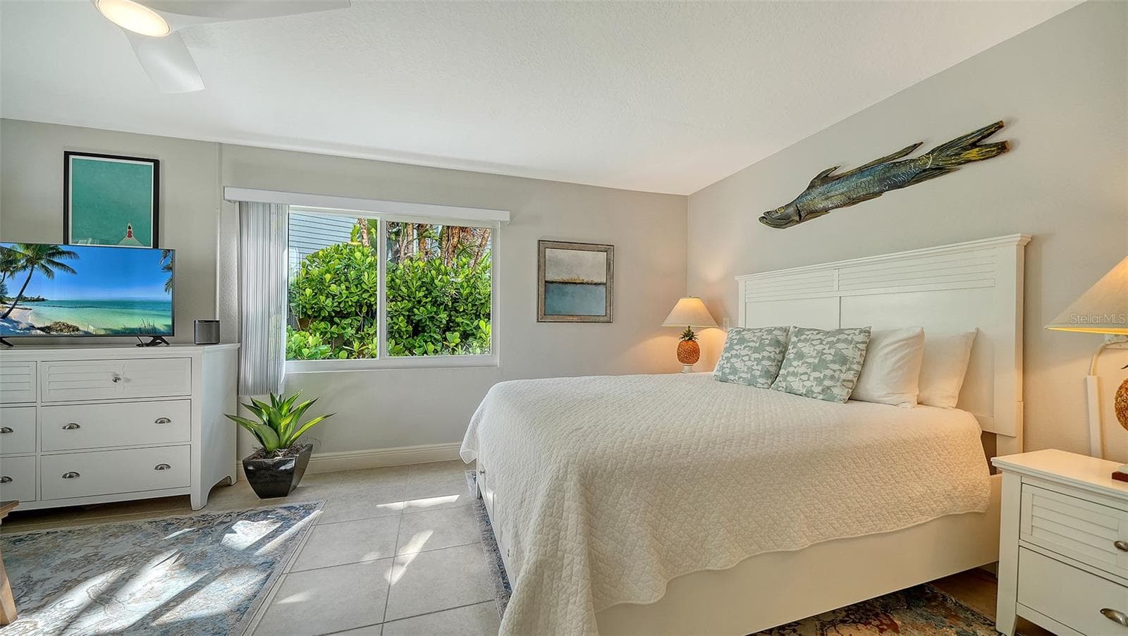 Light-filled bedroom surrounded by tropical views. - SARASOTA