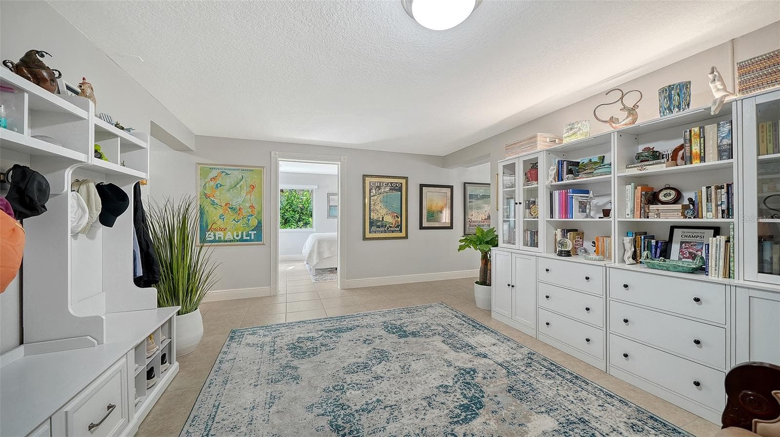Custom built-ins provide exceptional storage in the lower-level bonus area. - SARASOTA