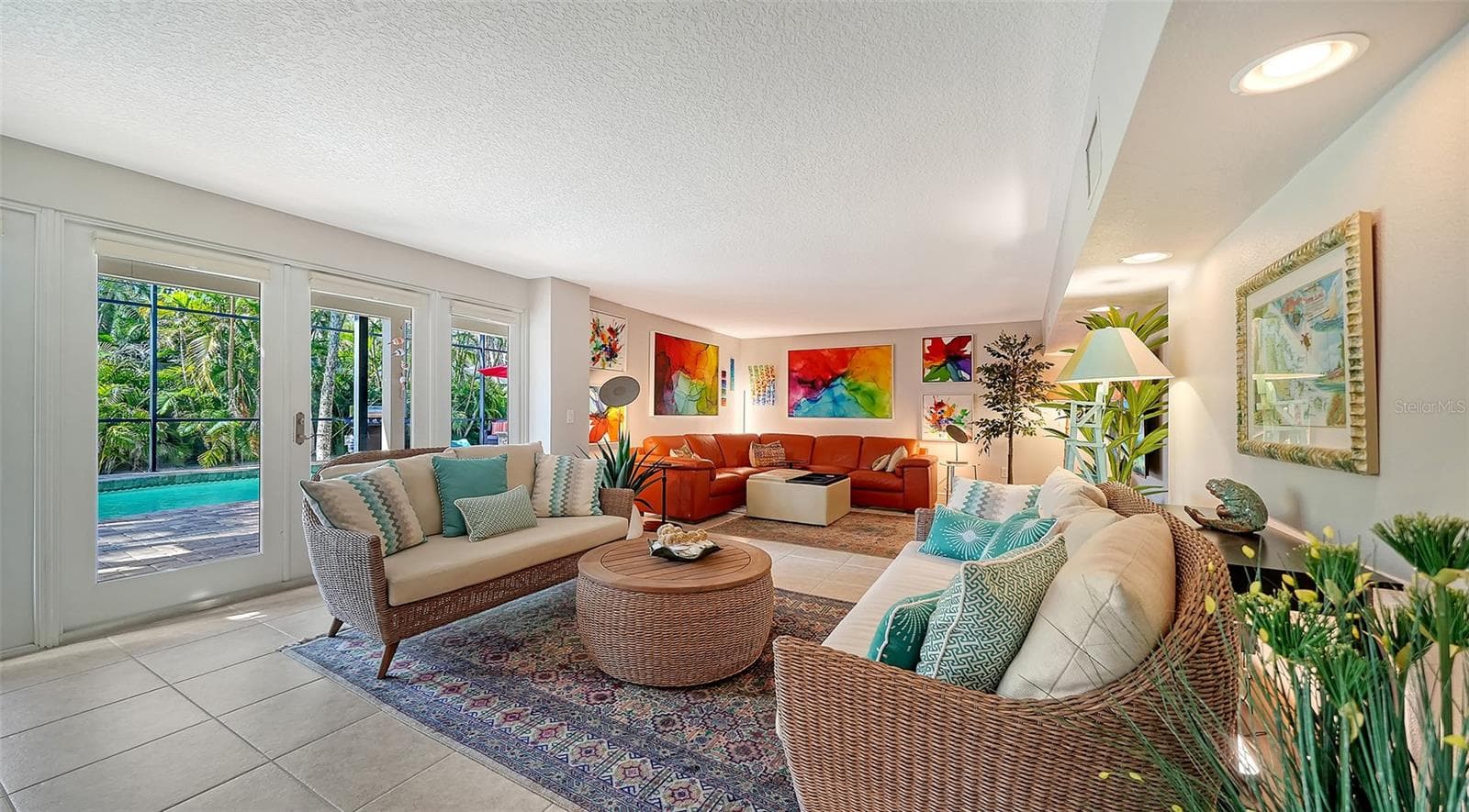 Large family room with direct access to the screened pool and lanai. - SARASOTA