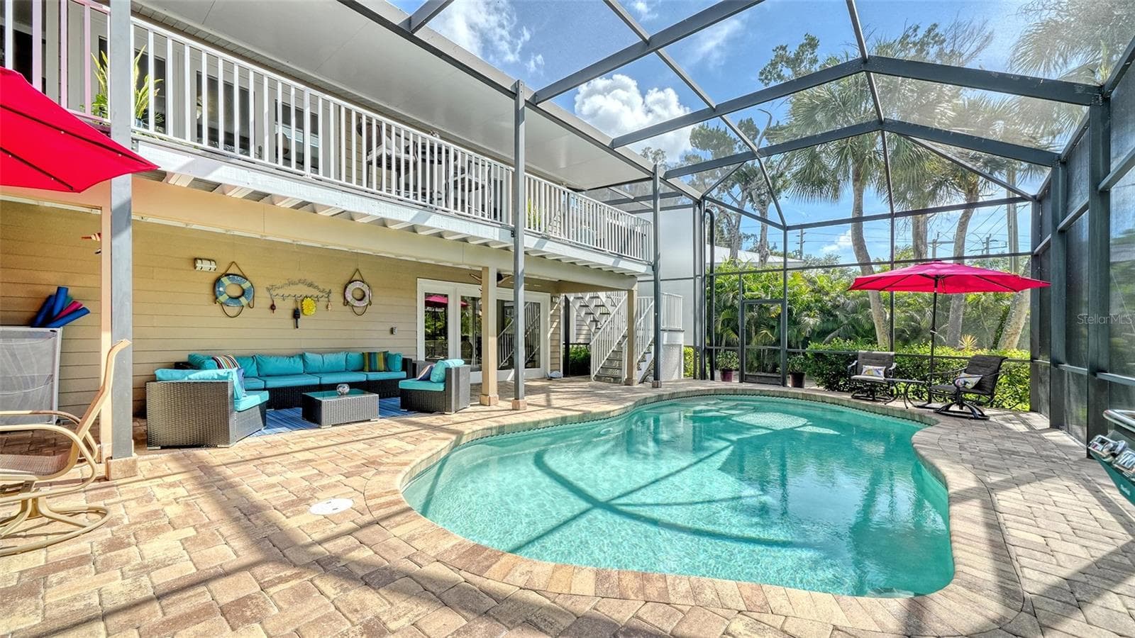 Heated saltwater pool surrounded by a screened enclosure and generous paver deck. - SARASOTA
