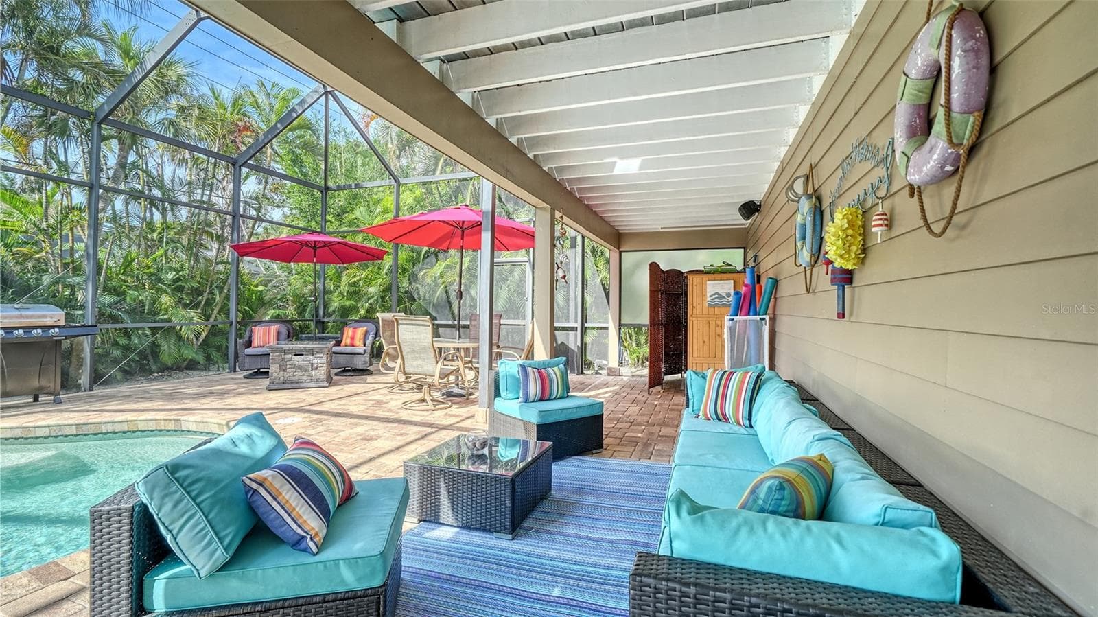 Covered poolside seating creates a comfortable shaded retreat. - SARASOTA