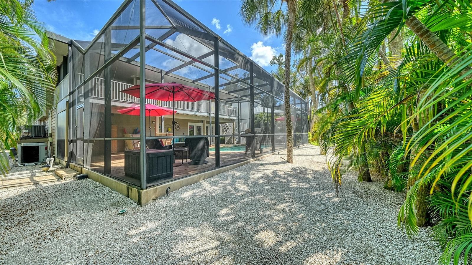 Spacious screened pool enclosure with resurfaced paver deck. - SARASOTA