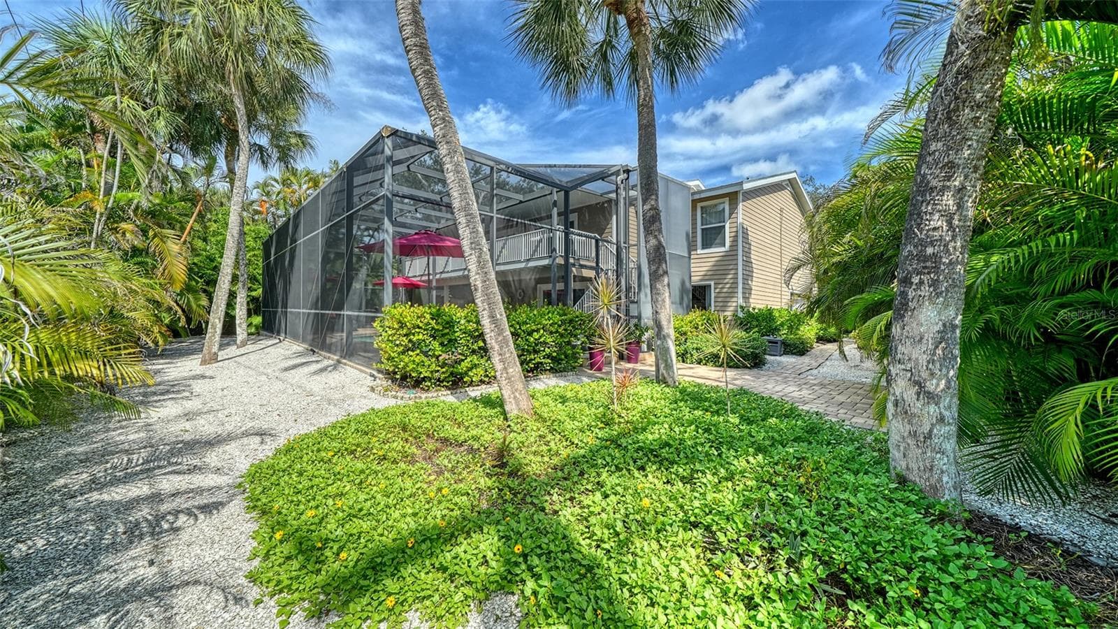Lush landscaping surrounds the home and enhances its private island setting. - SARASOTA