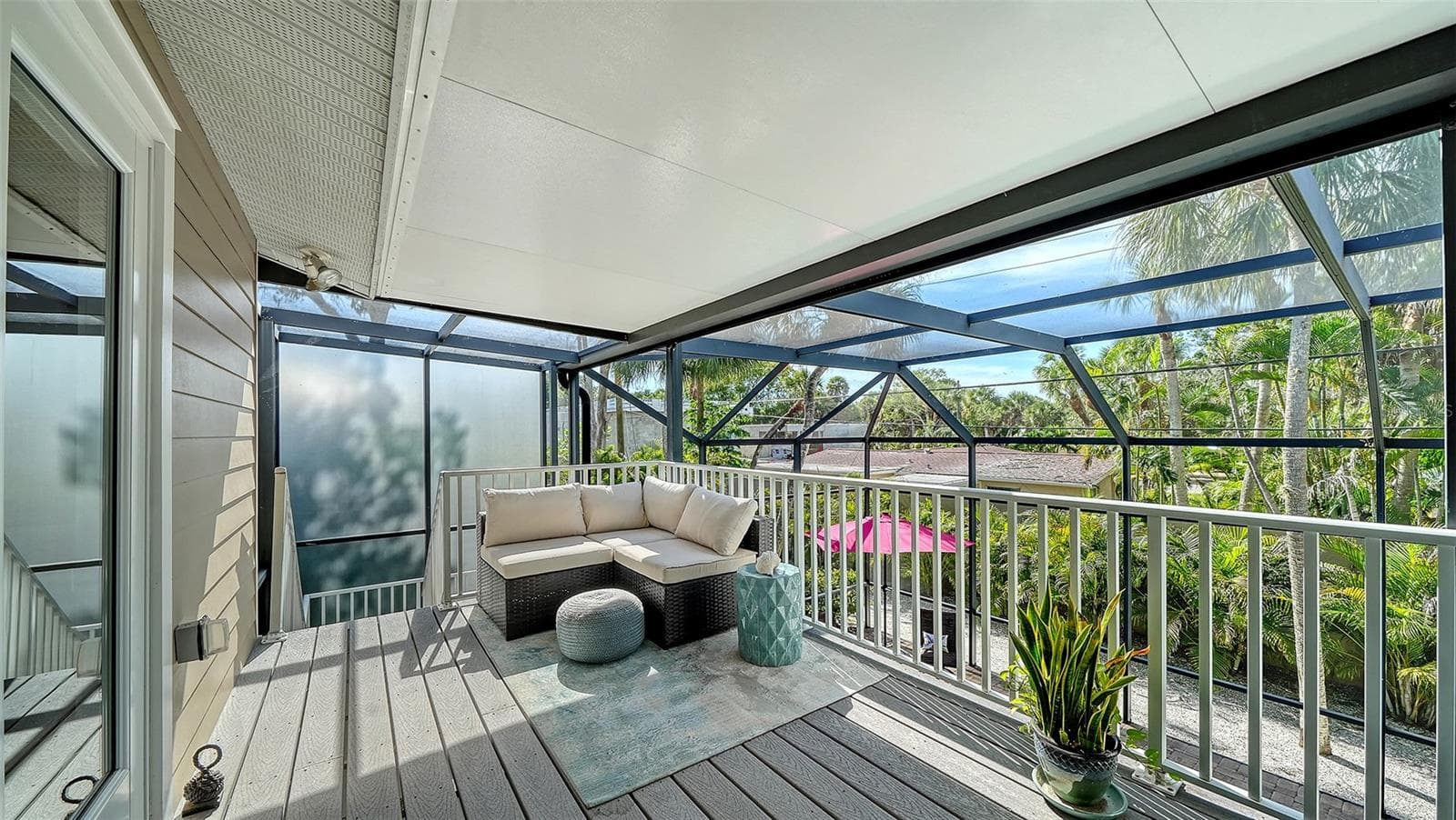 Another inviting screened balcony provides a peaceful place to enjoy the tropical surroundings. - SARASOTA