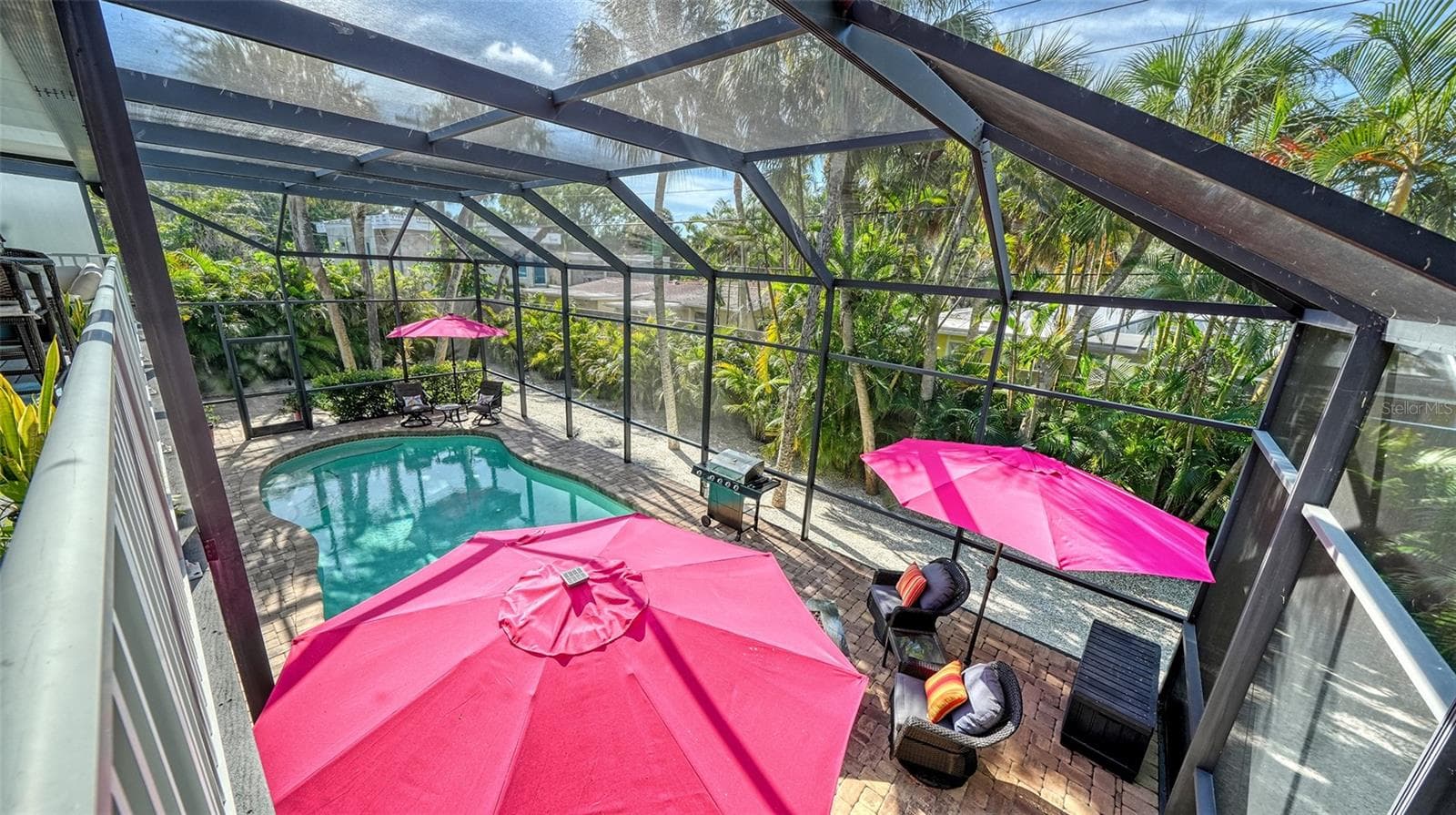 Elevated view overlooking the heated pool and expansive screened lanai. - SARASOTA