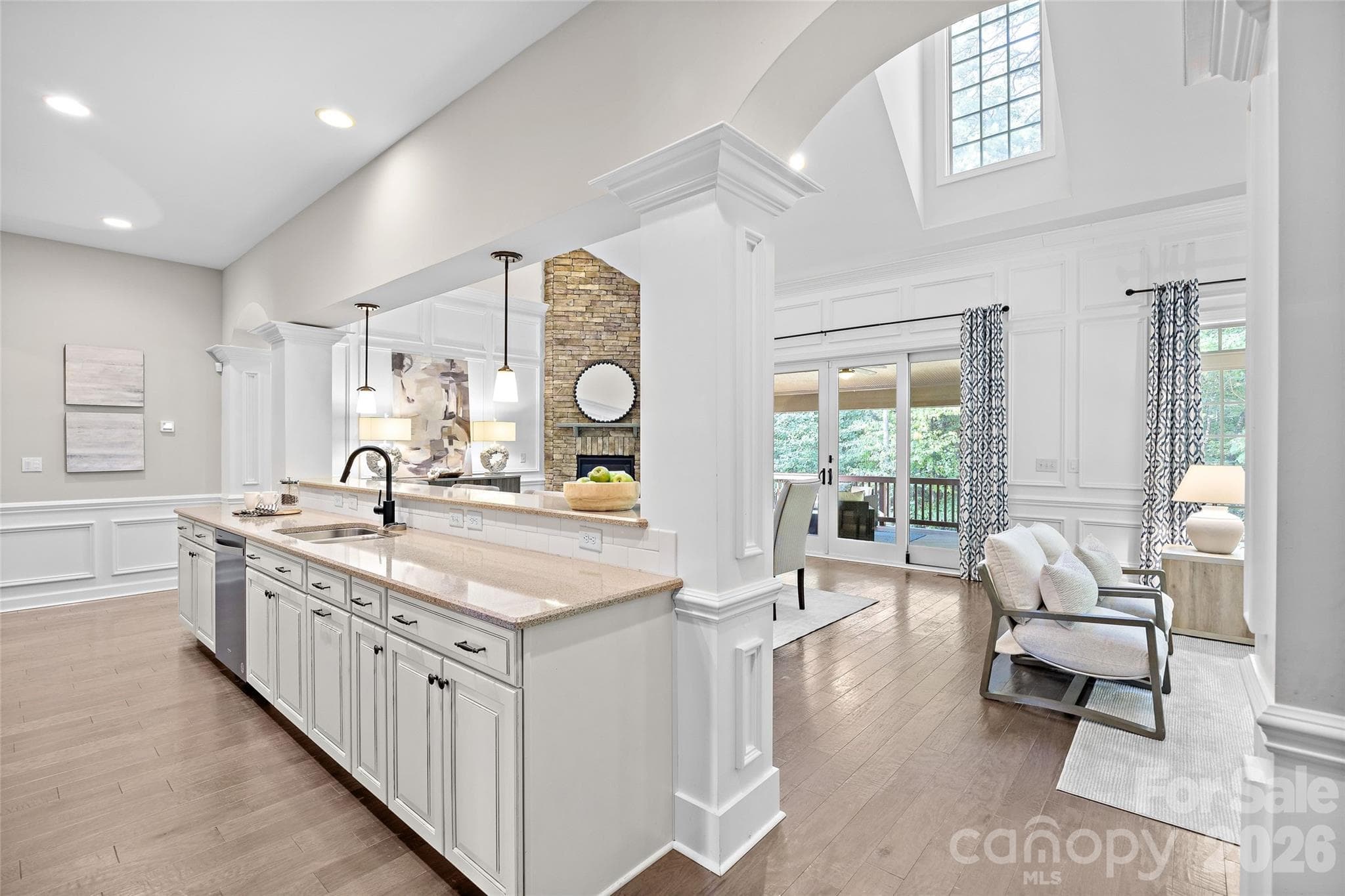 The kitchen is open to the breakfast area and den with a gorgeous vaulted ceiling and lots of windows that overlook a wooded backyard - 1623 Hawkstone Drive, Waxhaw