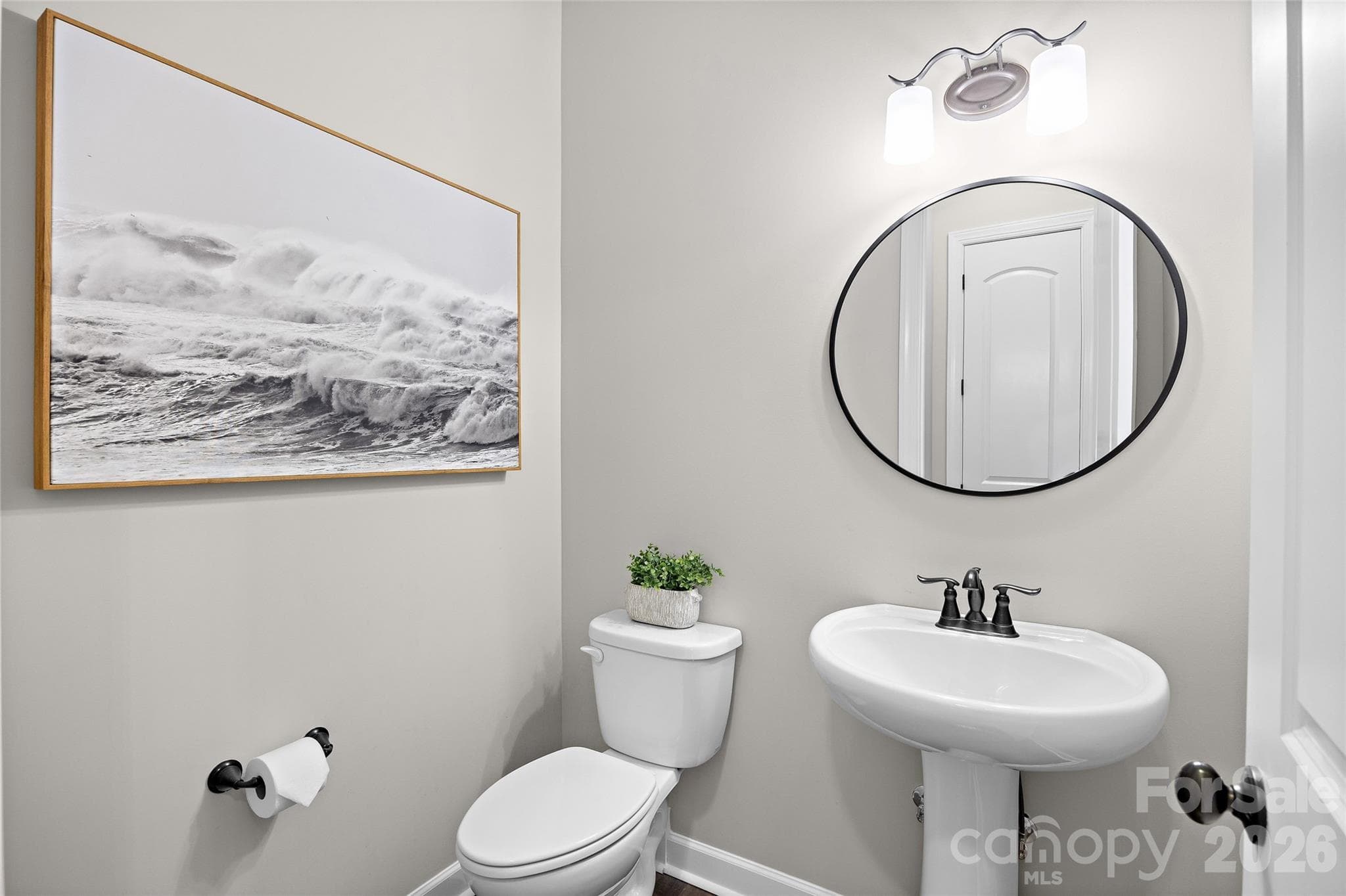 A half bath on the main level is convenient for having guests over and entertaining - 1623 Hawkstone Drive, Waxhaw