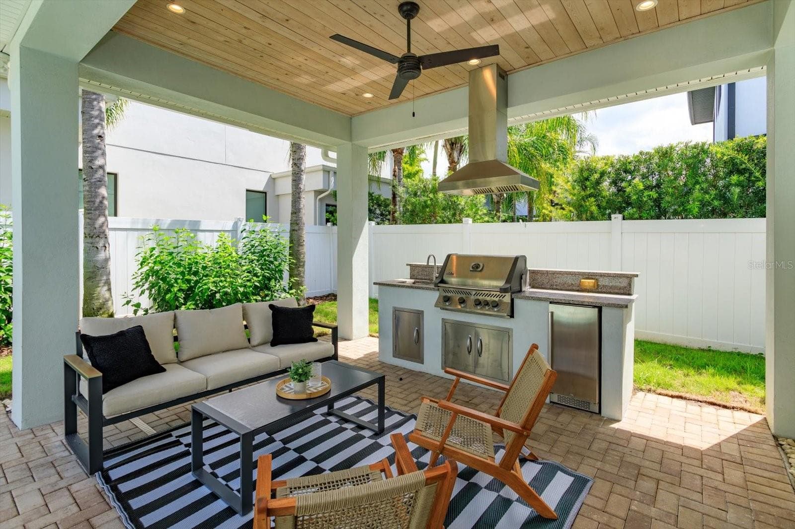 Brick paver lanai with summer kitchen with Napoleon gas grill, beverage fridge and vent hood - 533 COUNTRY CLUB DR, WINTER PARK