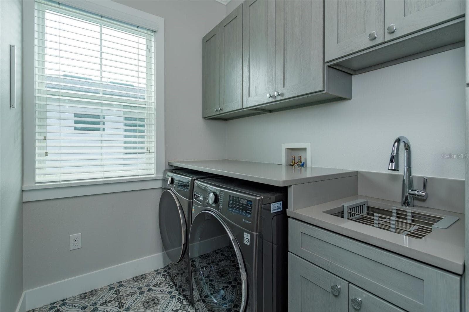 Second floor laundry room with utility sink and cabinetry - 533 COUNTRY CLUB DR, WINTER PARK
