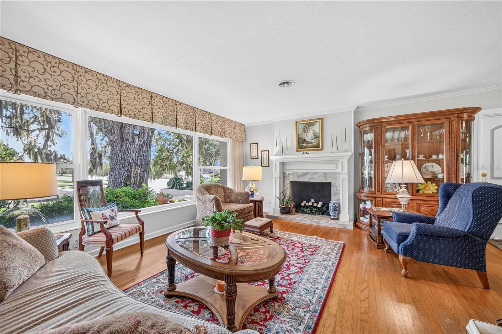 Living room with wood burning fireplace. - 1205 DORCHESTER ST, ORLANDO