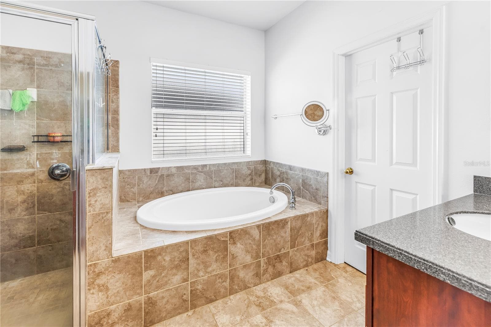 Primary Bath With Soaking Tub and Door to Walk-in Closet - 7717 TANGLE BROOK BLVD, GIBSONTON