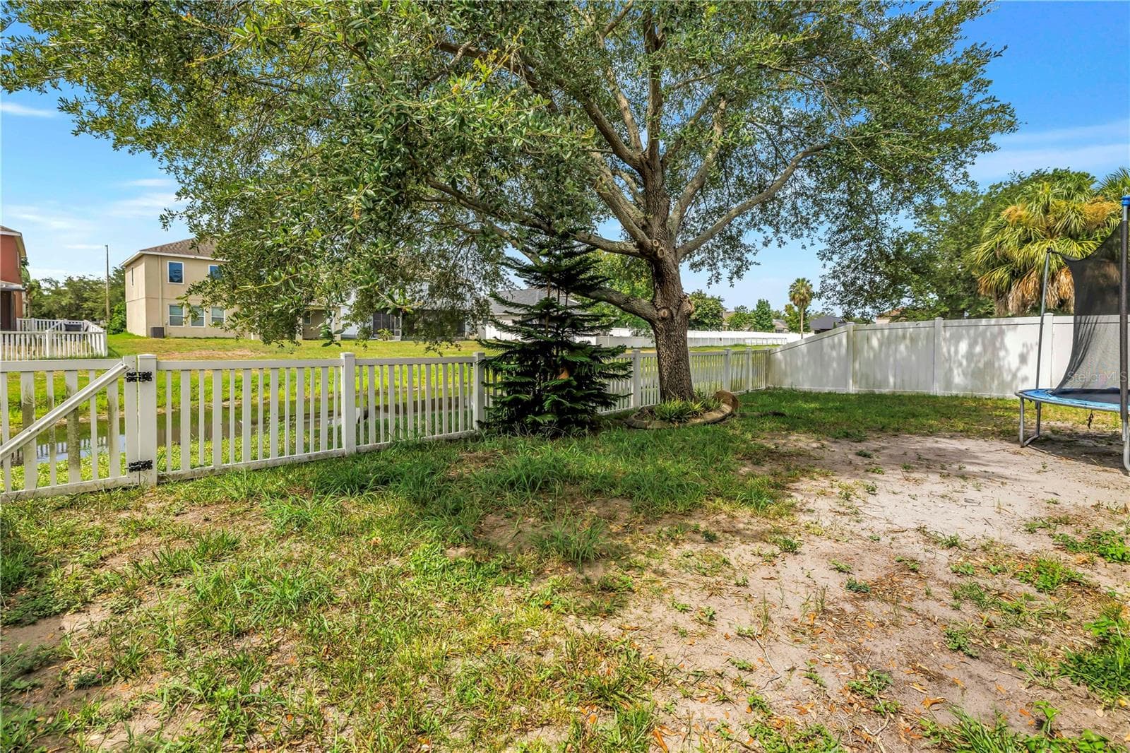 Backyard With Fence and Water View - 7717 TANGLE BROOK BLVD, GIBSONTON