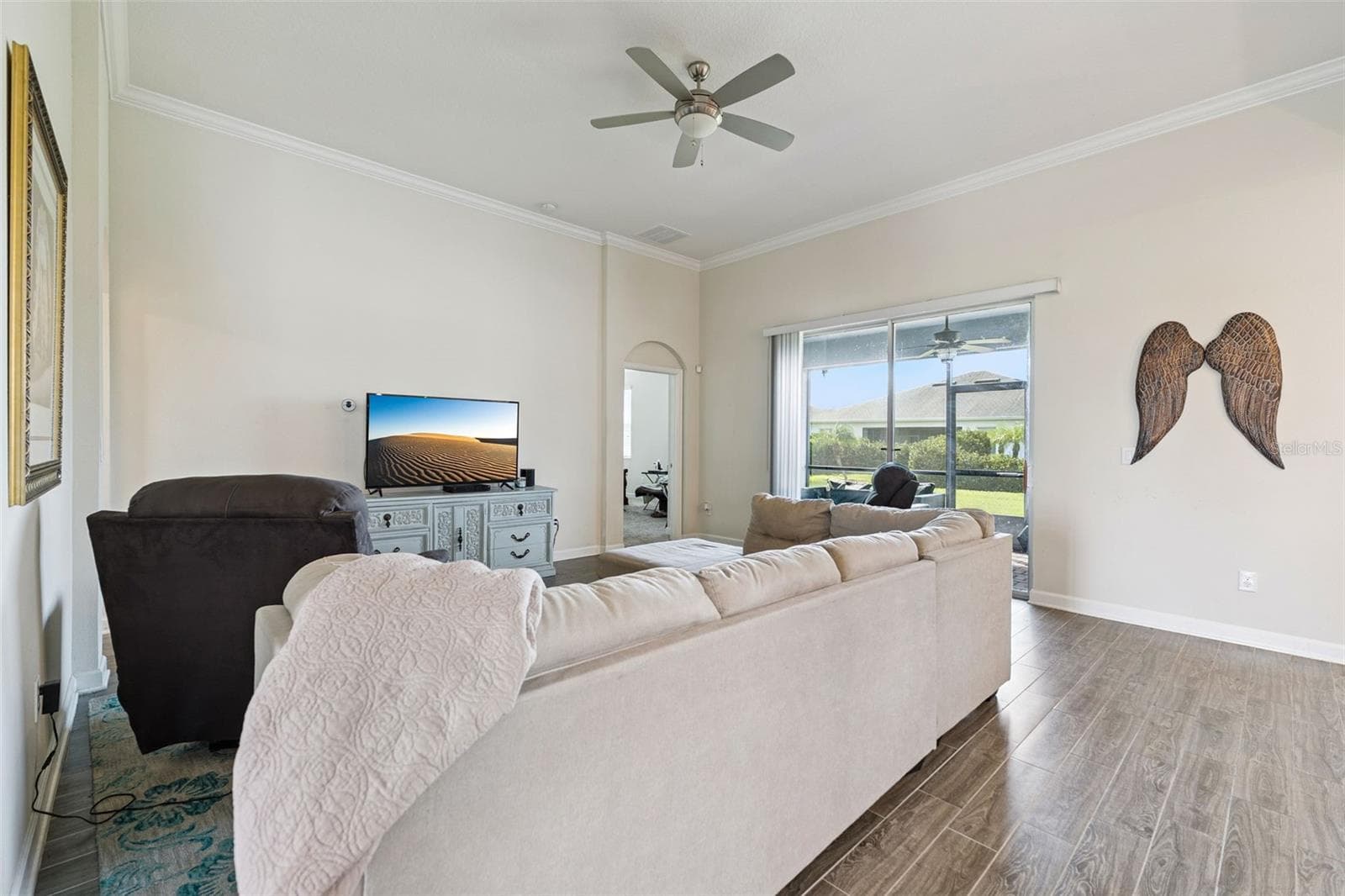 Oversized glass sliding doors provide an abundance of natural light and open seamlessly to the screened-in lanai, creating an effortless flow between indoor and outdoor living - 4075 BEDFORD AVE, WINTER HAVEN