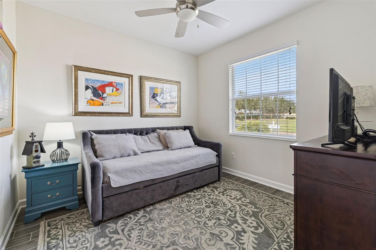 The versatile Den is an inviting retreat with beautiful views overlooking Lake Ruby, making it an ideal home office, reading room, or additional living space. - 4075 BEDFORD AVE, WINTER HAVEN