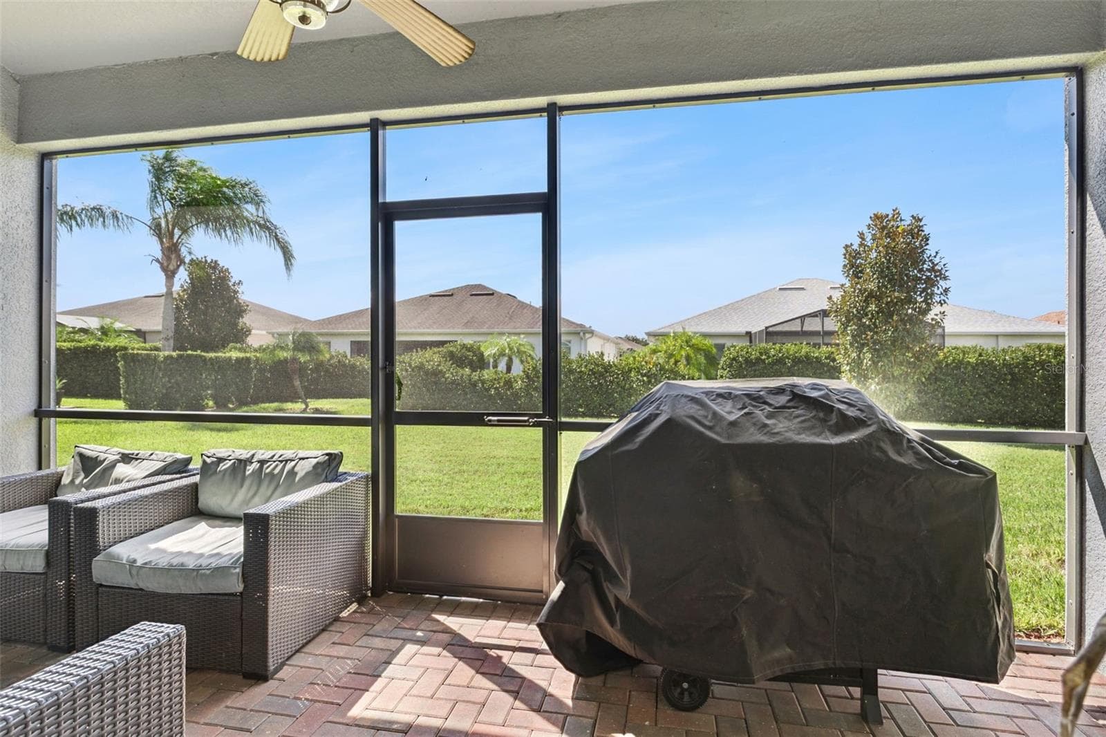 Screened-in lanai, beautifully finished with pavers and offering a peaceful space to relax, entertain, and enjoy the Florida lifestyle - 4075 BEDFORD AVE, WINTER HAVEN