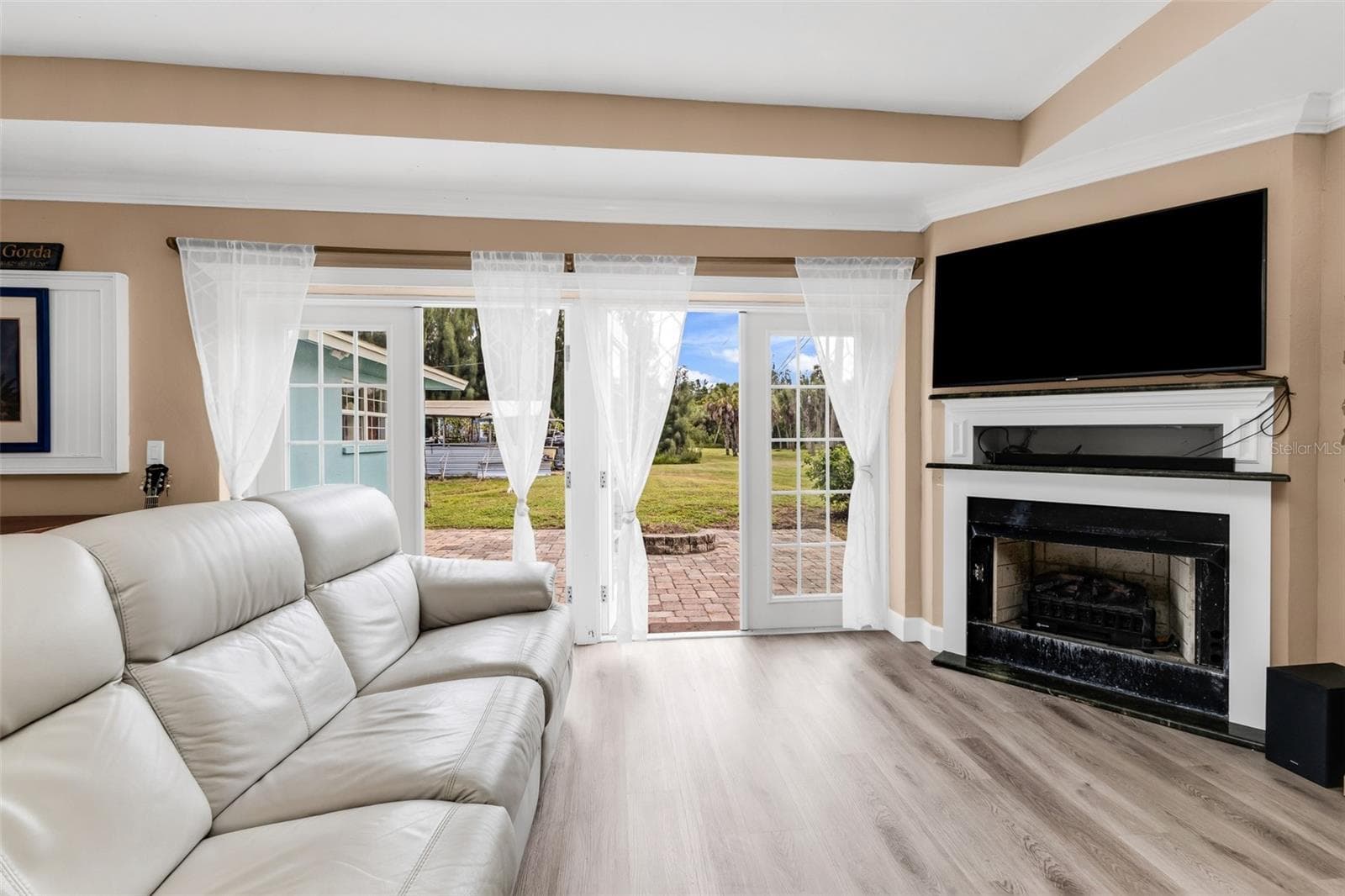 Living room with fireplace and French doors - 3407 ISLAND VIEW DR, PUNTA GORDA
