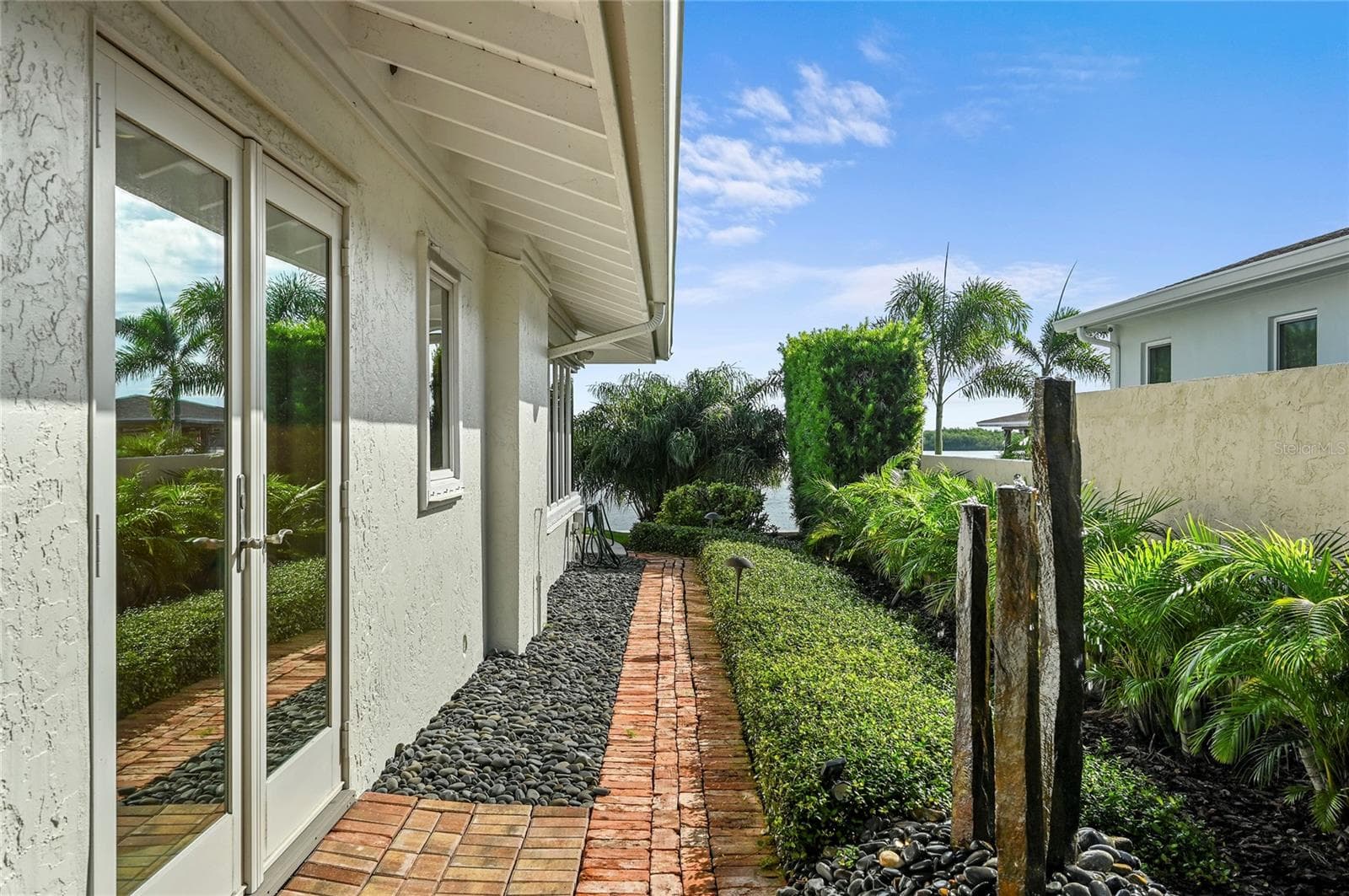 Tropical Landscaping and Artistic Accents create a Paradise you'll never want to leave - 1215 COMMODORE DR, NEW SMYRNA BEACH
