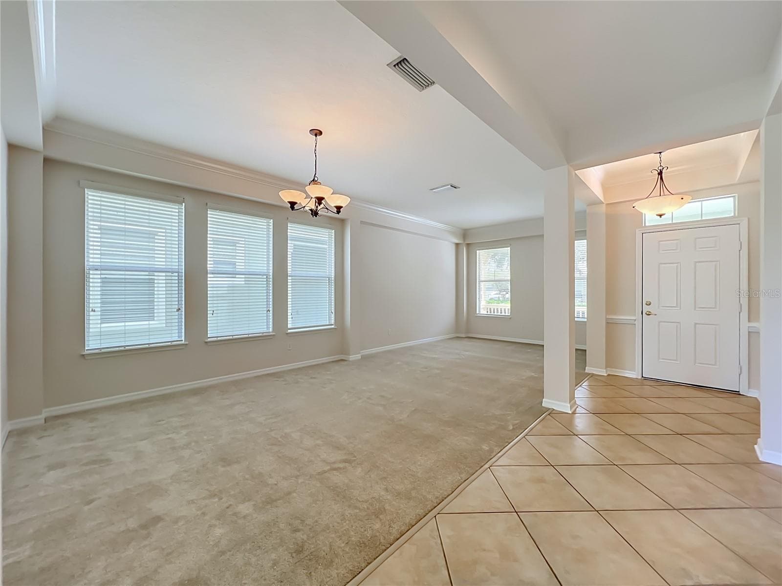 Living room/Dining room combination with high ceilings, crown moldings, Ceramic tile at the front door entryway - 12809 HOLDENBURY LN, WINDERMERE