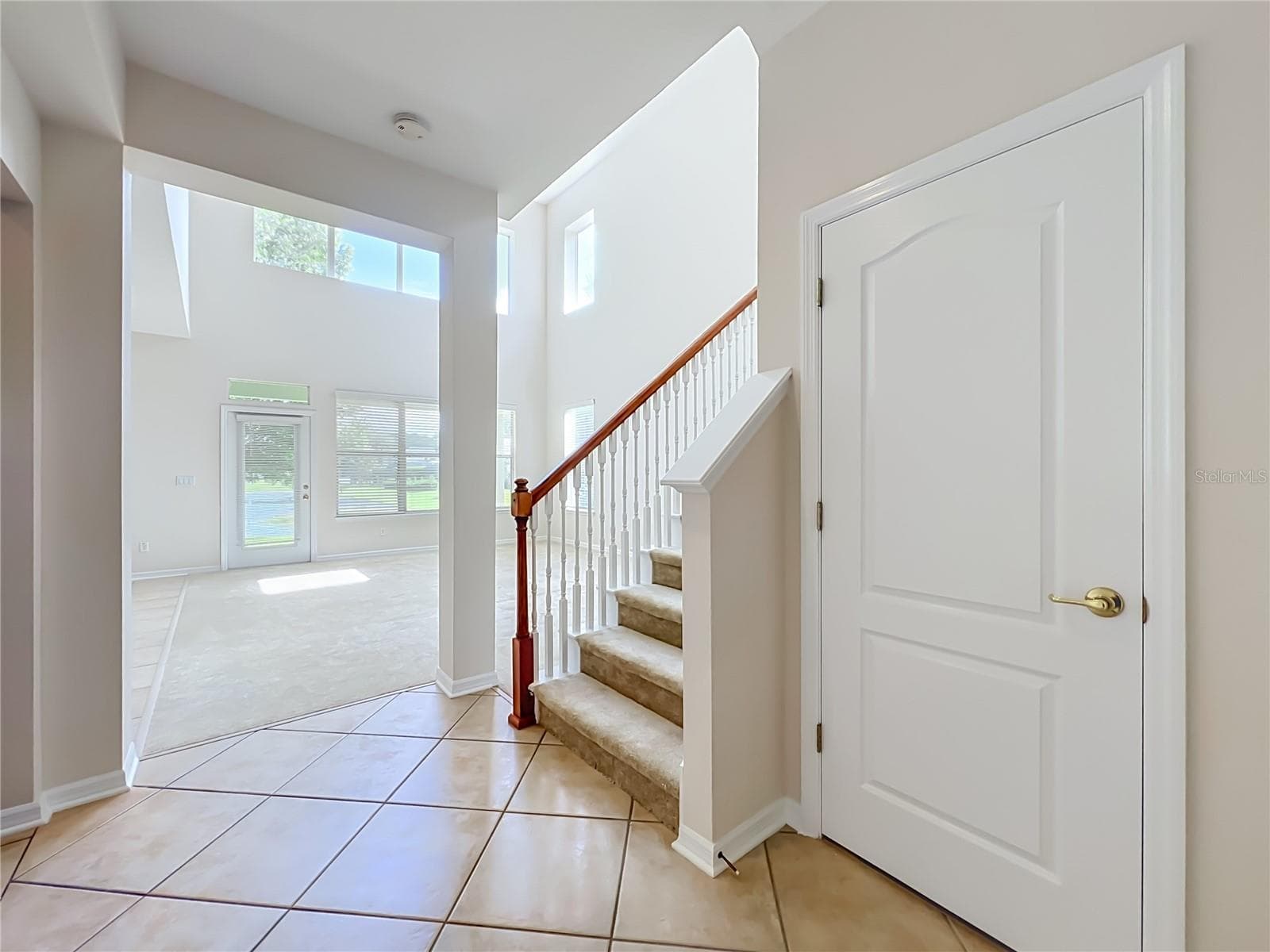 Hall closet and carpeted stairway in the center of the home - 12809 HOLDENBURY LN, WINDERMERE