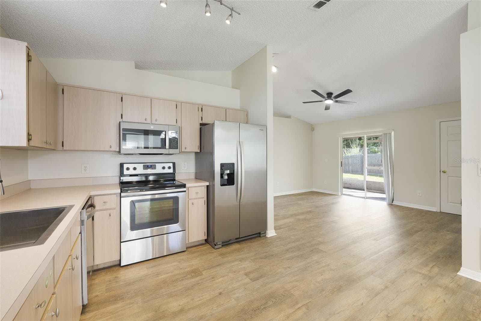 Open floorplan between kitchen/living/dining-den - 13659 GLASSER AVE, ORLANDO