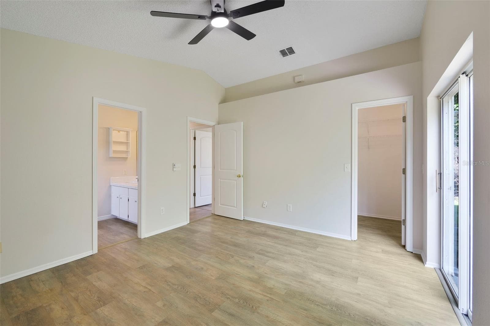 Walk-in closet and ceiling fan in the primary bedroom - 13659 GLASSER AVE, ORLANDO