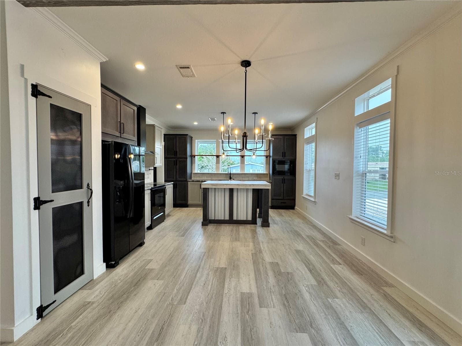 The dining room separates the kitchen and living room. - 9248 SCEPTER AVE, BROOKSVILLE