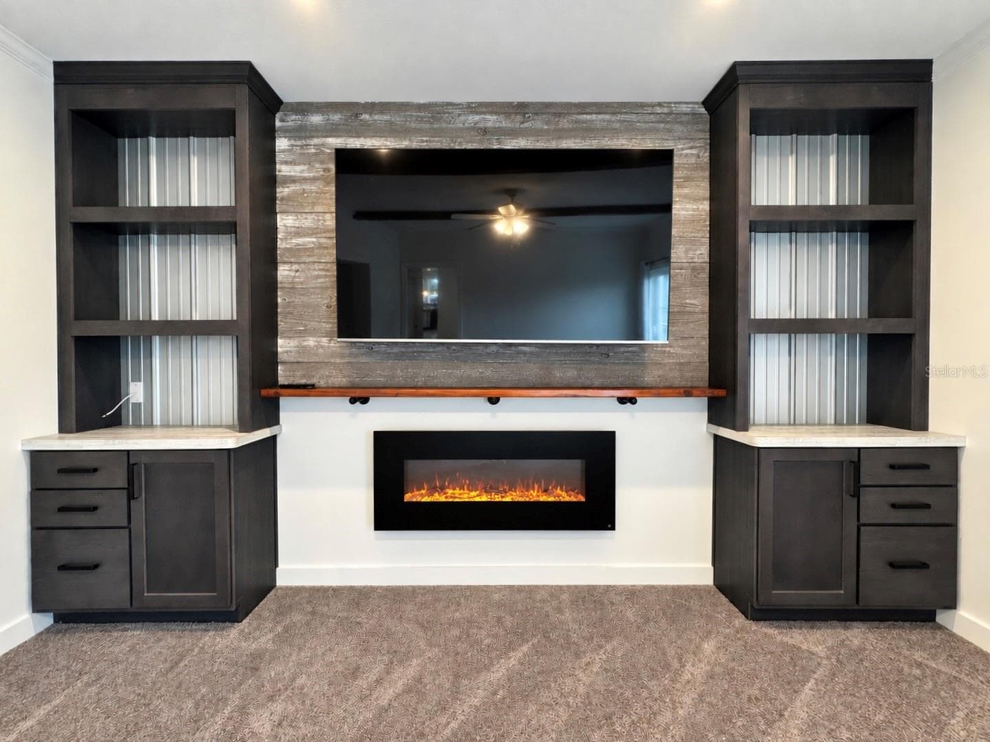 Fireplace in family room with wall-mounted tv ad built-in shelves. - 9248 SCEPTER AVE, BROOKSVILLE