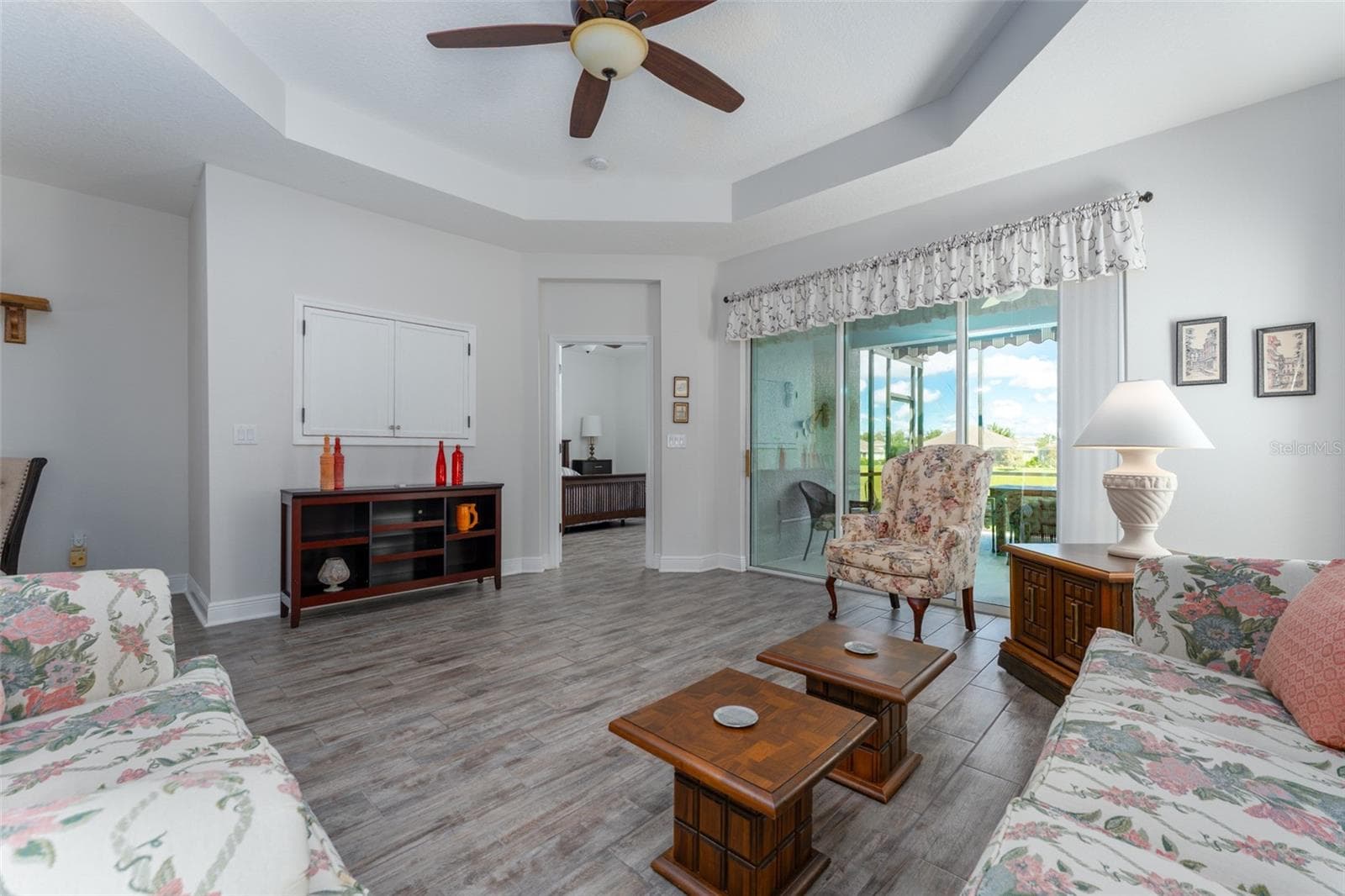 What's not to love here!! Charming light infused 2 bedroom, 2 bath villa with office in the gated village of Sagewood in Fishhawk West. Sitting pretty on a private lot with no back or side neighbors and adjacent to the wooded green space and extra parking. Walk up the sidewalk to the cozy covered front porch and screened entryway. Step inside onto neutral staggered tile flooring that flows throughout the main living areas with engineered wood flooring in the office and carpet in the two bedrooms. The kitchen features white cabinetry with crown tops, granite counters, tile backsplash and GE SS appliances including gas range/oven, microwave, fridge and Bosch dishwasher in the center island with pendant lighting and additional seating. The kitchen is open to the great room with coffered ceiling and the dining area. The great room overlooks the covered extended screened lanai accessible through sliding glass doors extending your living space to the outdoors with views to the natural green space directly behind th - 13533 CIRCA CROSSING DR, LITHIA