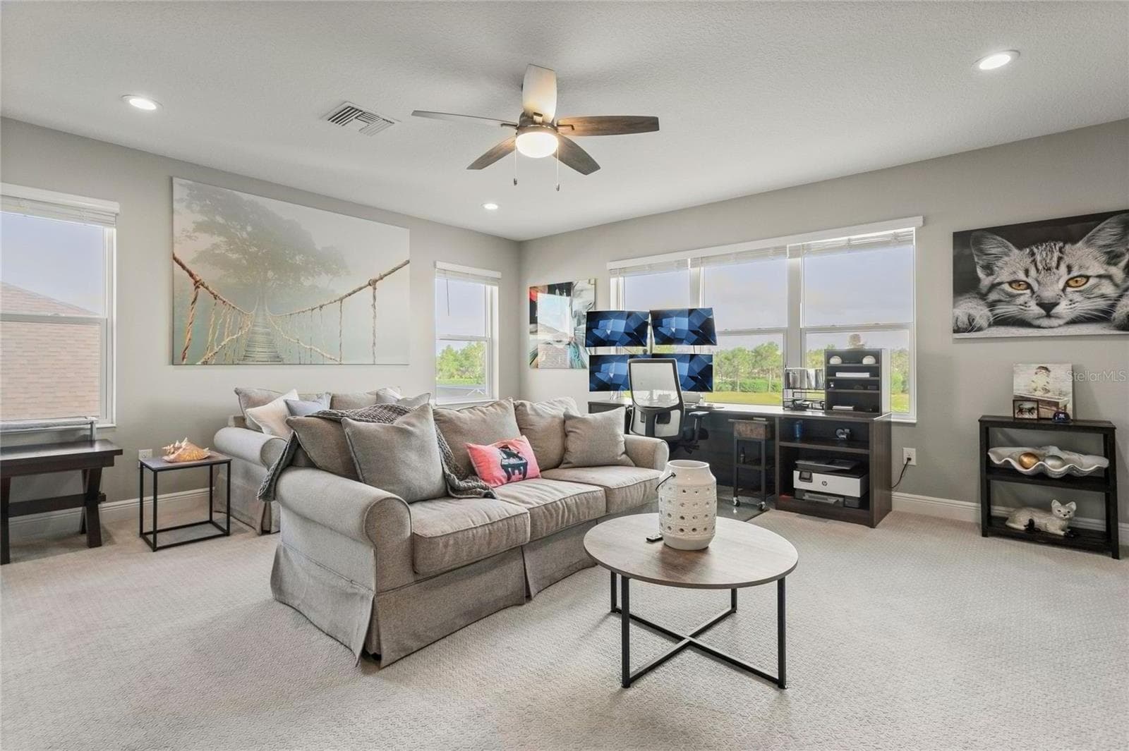 Spacious upstairs loft with natural light, neutral finishes, and flexible space ideal for lounging, work, or play—located next to the Jack-and-Jill bathroom and bonus bedroom - 10625 FALLING LEAF CT, PARRISH