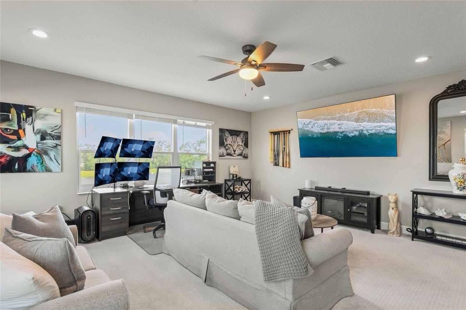 Upstairs loft with a premium homesite view, abundant natural light, neutral finishes, and a spacious layout ideal for flexible living—located beside the Jack-and-Jill bathroom and bonus bedroom. - 10625 FALLING LEAF CT, PARRISH