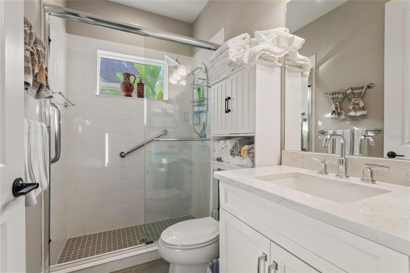 Bathroom next to the secondary bedroom and Media Room with modern finishes, walk-in shower, and a bright, functional layout. - 10625 FALLING LEAF CT, PARRISH