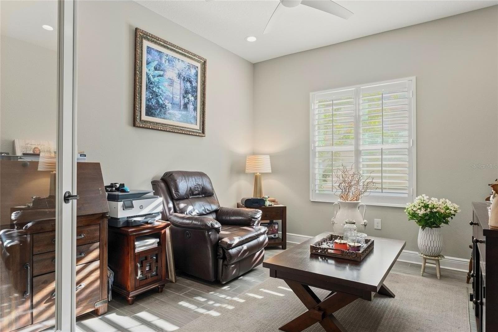 Media room with a comfortable layout, plantation shutters, and a quiet, flexible space ideal for work, entertainment, or relaxation. - 10625 FALLING LEAF CT, PARRISH