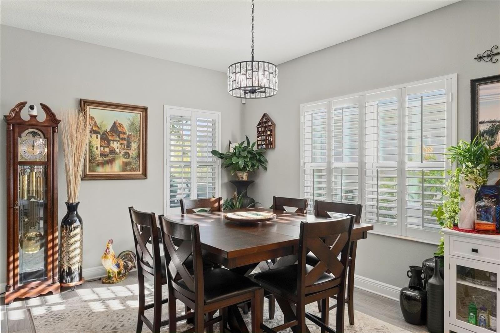 Dining area with bright natural light, plantation shutters, and a spacious layout that flows seamlessly from the kitchen for comfortable everyday use and entertaining - 10625 FALLING LEAF CT, PARRISH