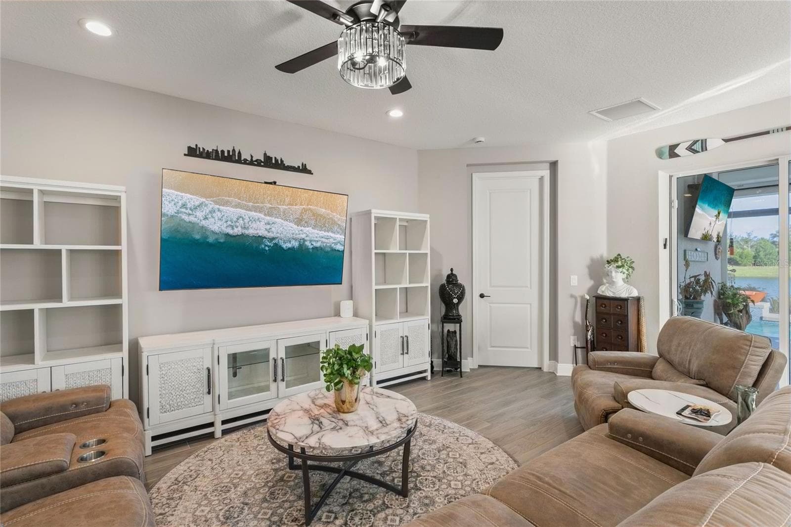 This open living space also transitions smoothly toward the primary bedroom, creating a convenient and private flow between the main gathering areas and the home’s primary suite - 10625 FALLING LEAF CT, PARRISH