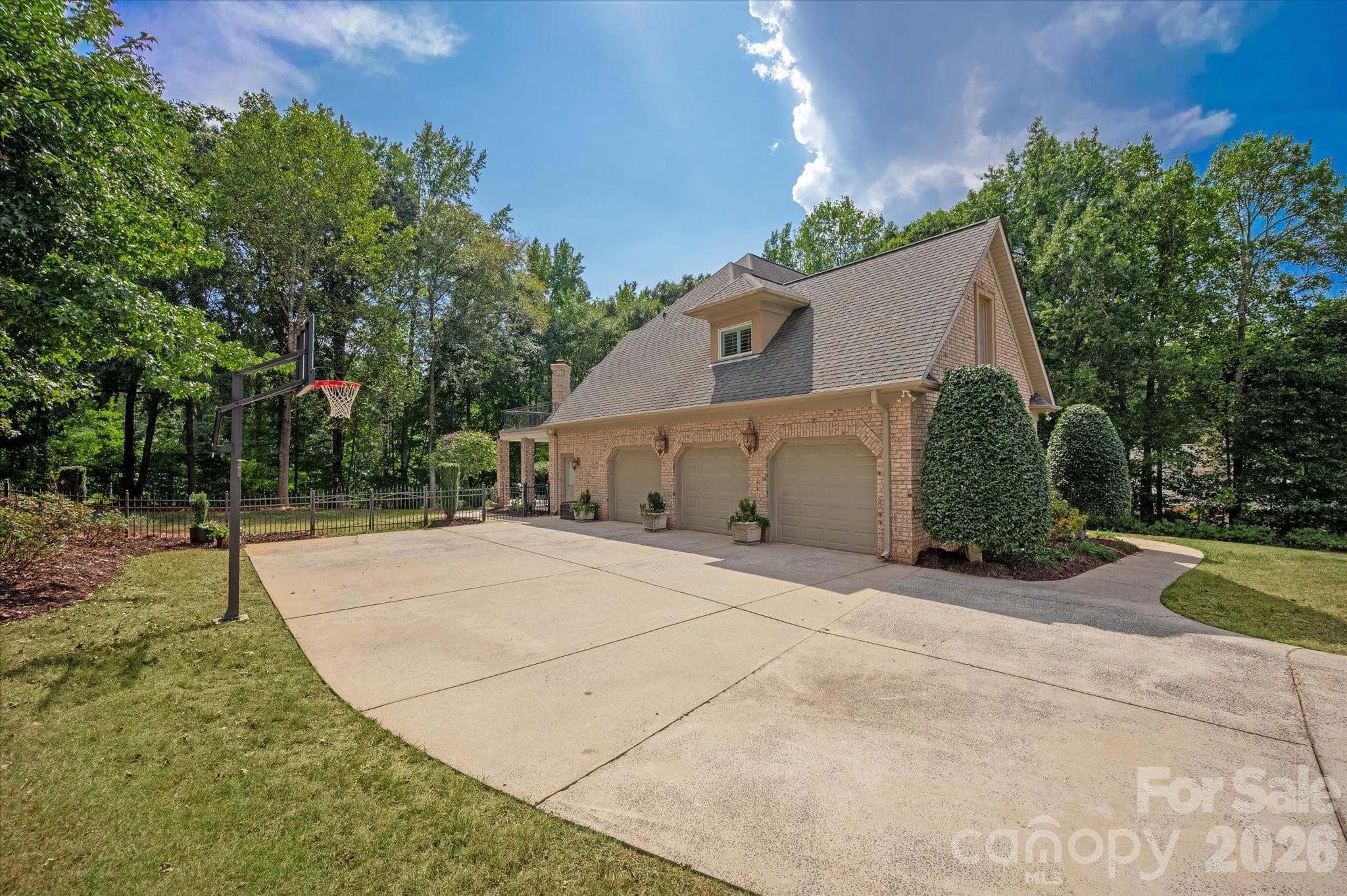 3 car side load garage with expansive driveway for additional parking - 1005 Firethorne Club Drive, Marvin
