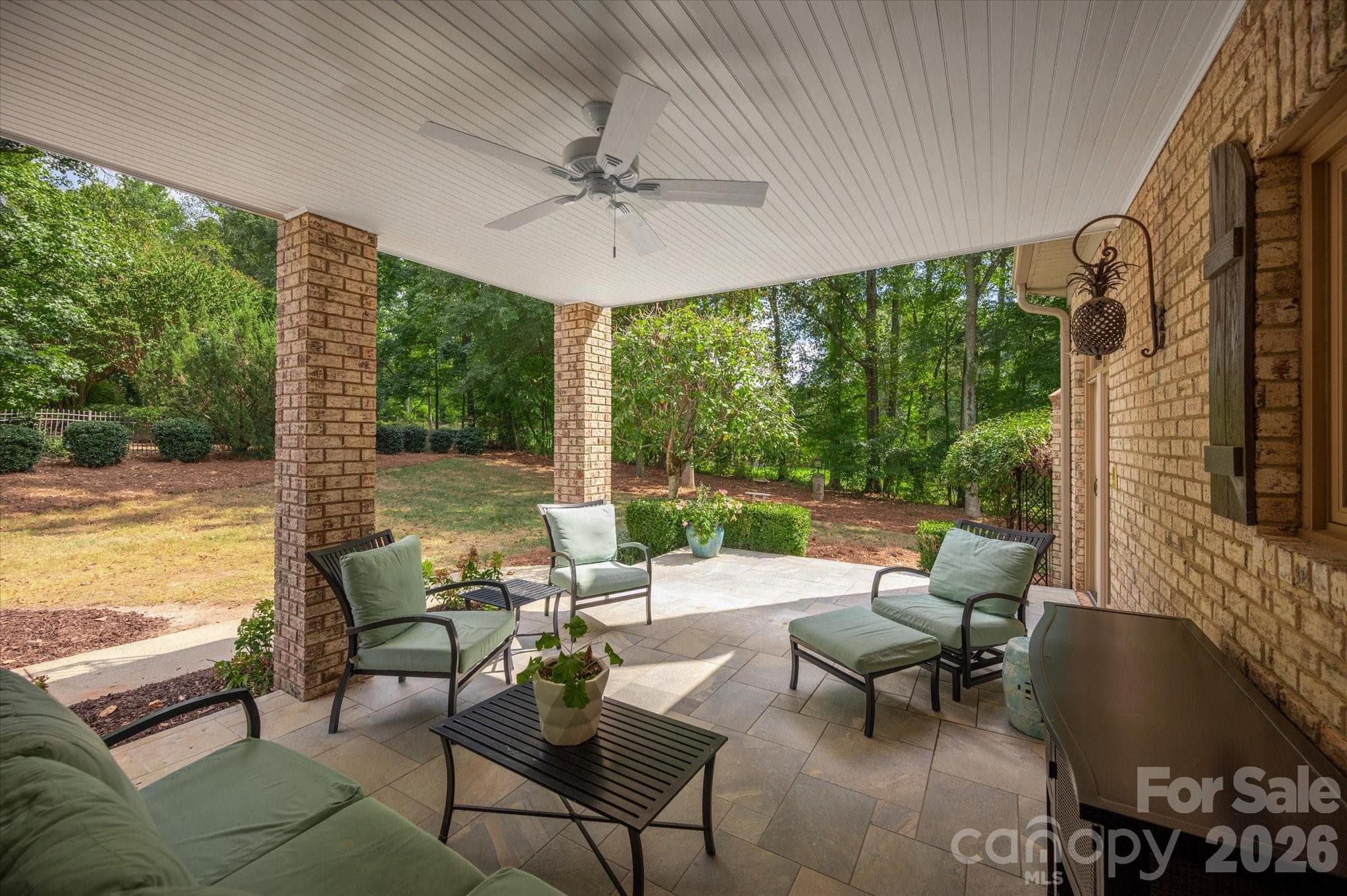 Covered rear porch with walk out terrace above - 1005 Firethorne Club Drive, Marvin