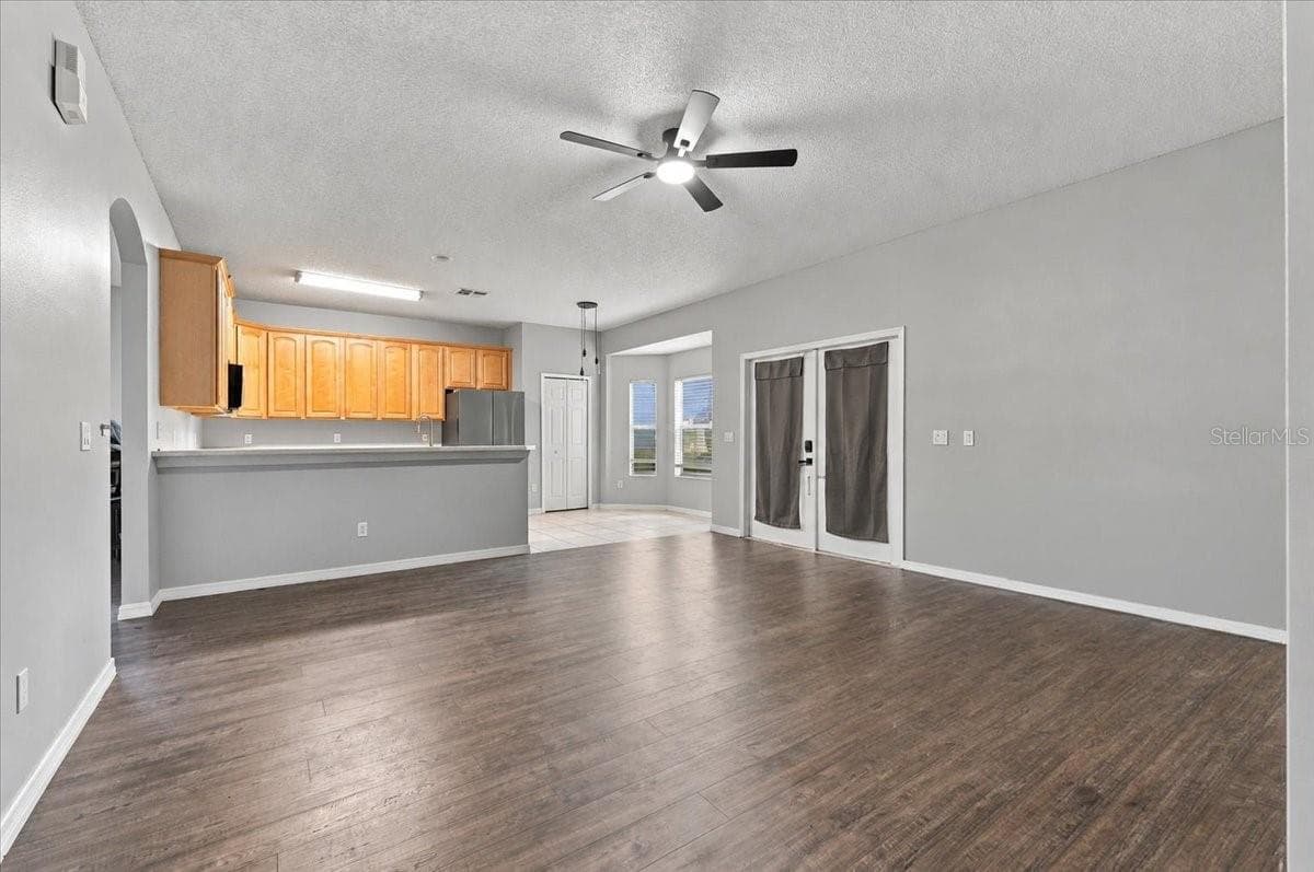 Family Room into Kitchen - 10003 AUTUMN CREEK LN, ORLANDO
