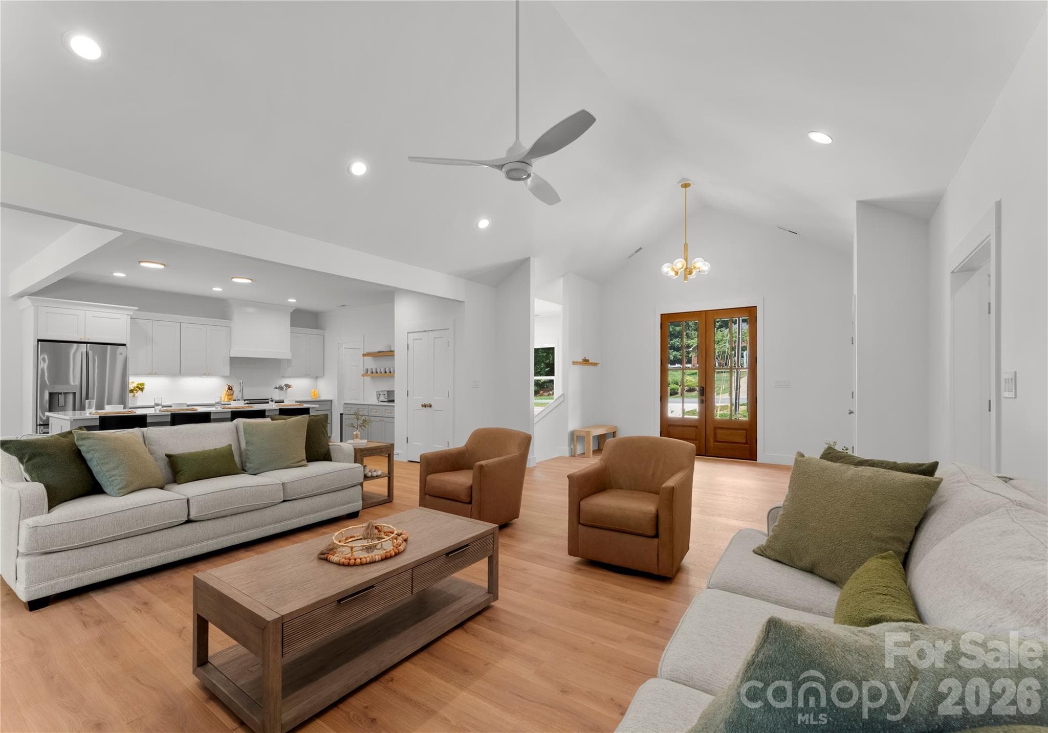 Warm wood floors and an open layout connect the main living spaces, offering plenty of room to relax or host guests. - 143 Hideaway Lane, Mooresville