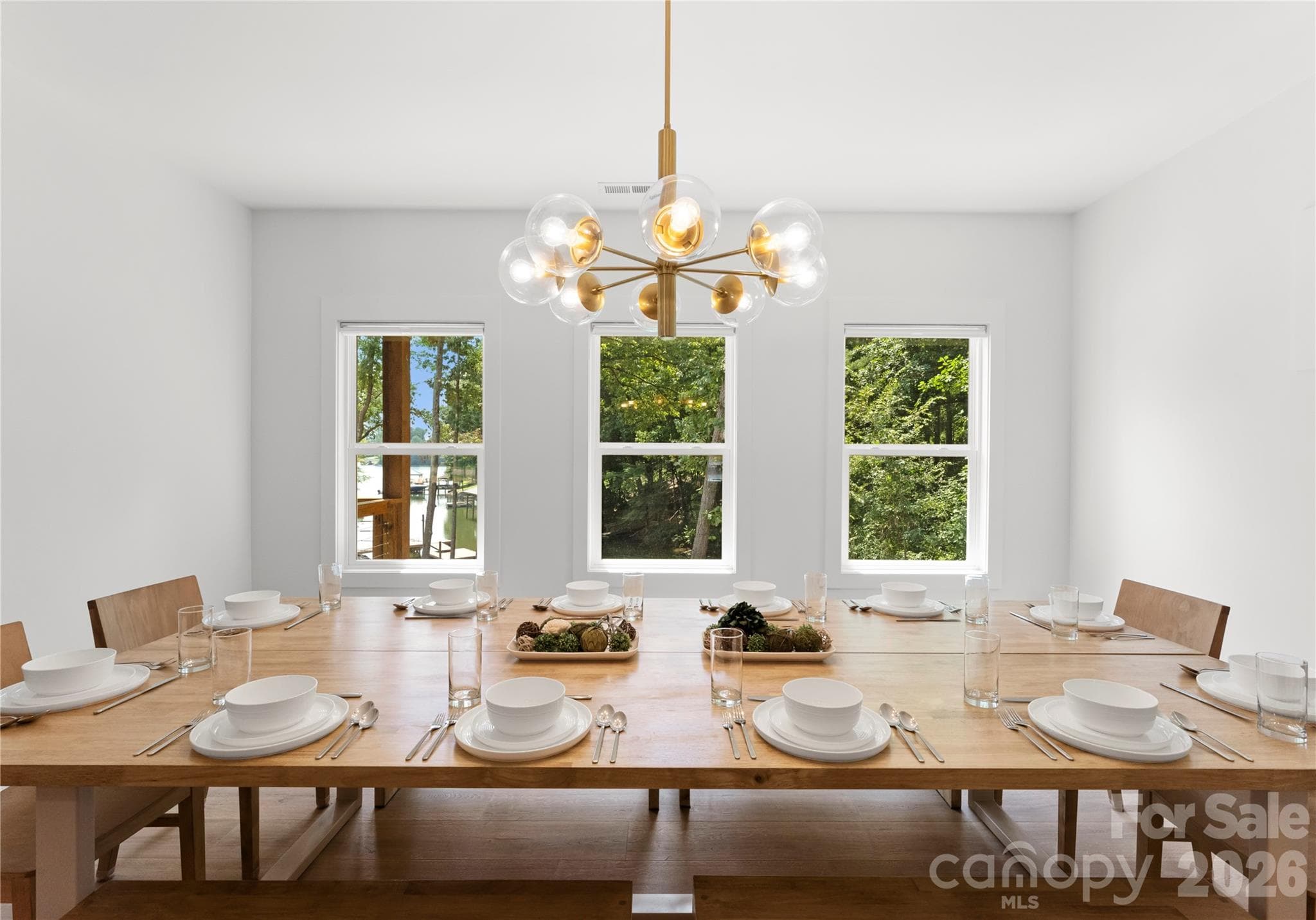 The dining area, an extension of the kitchen, sets the stage for lovely meals with long-range views across the property and down to the water. - 143 Hideaway Lane, Mooresville
