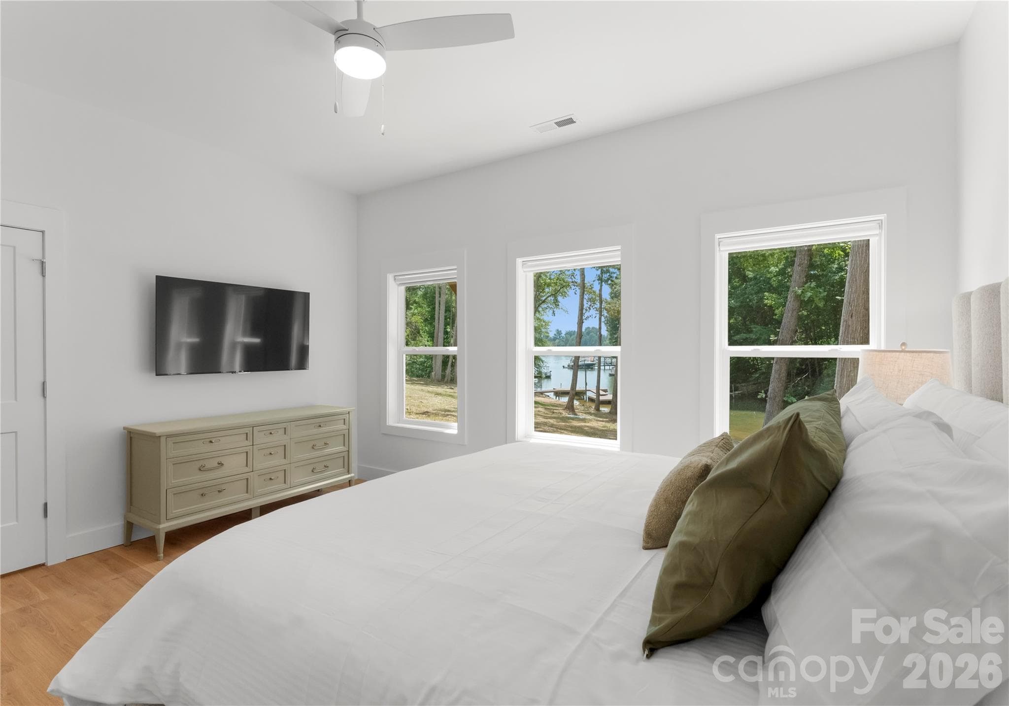 From this bedroom, enjoy a glimpse of the lake through the trees. - 143 Hideaway Lane, Mooresville