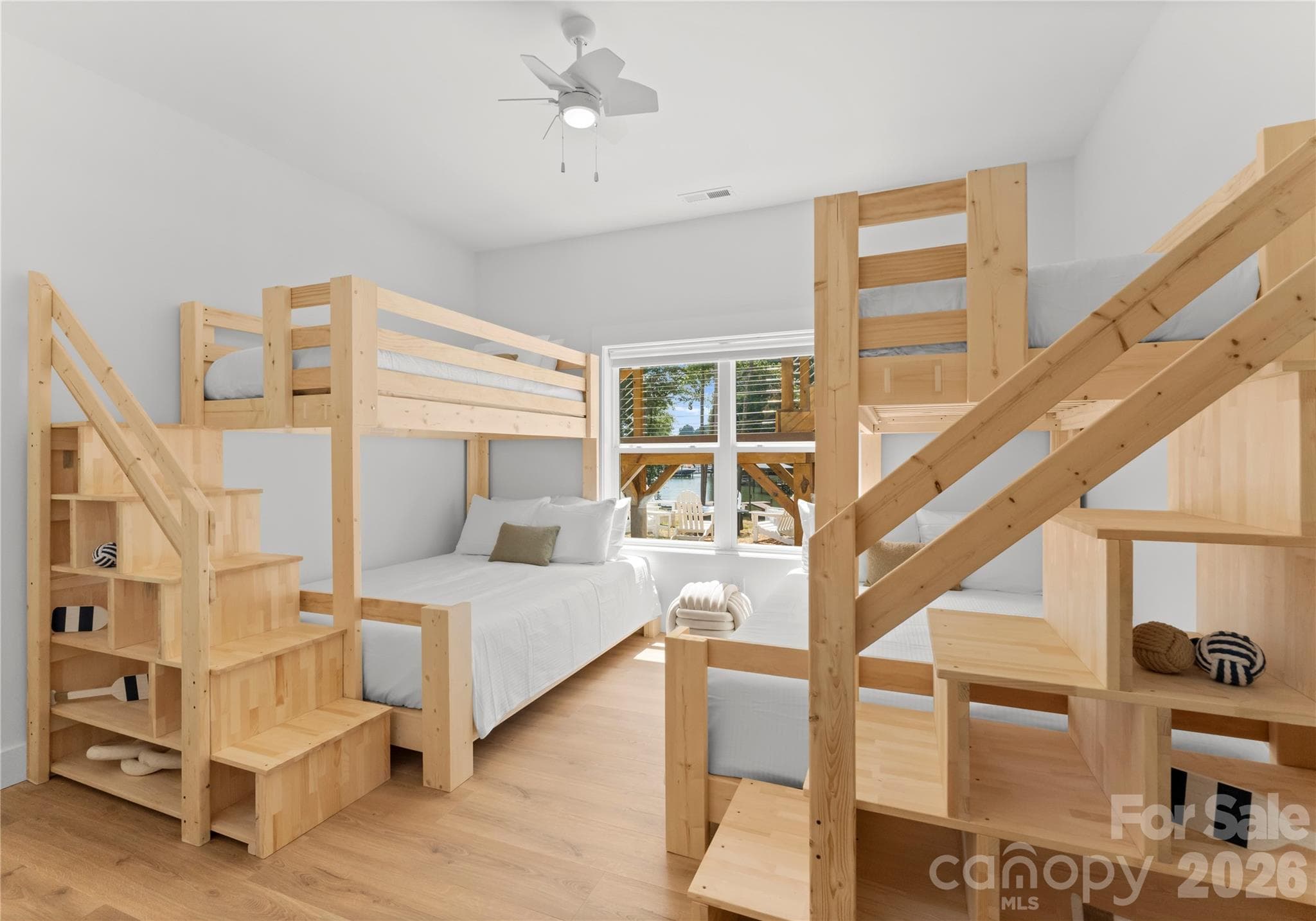 The bunk room offers a welcoming space for overnight guests, adding comfort and flexibility to this lakefront retreat. - 143 Hideaway Lane, Mooresville