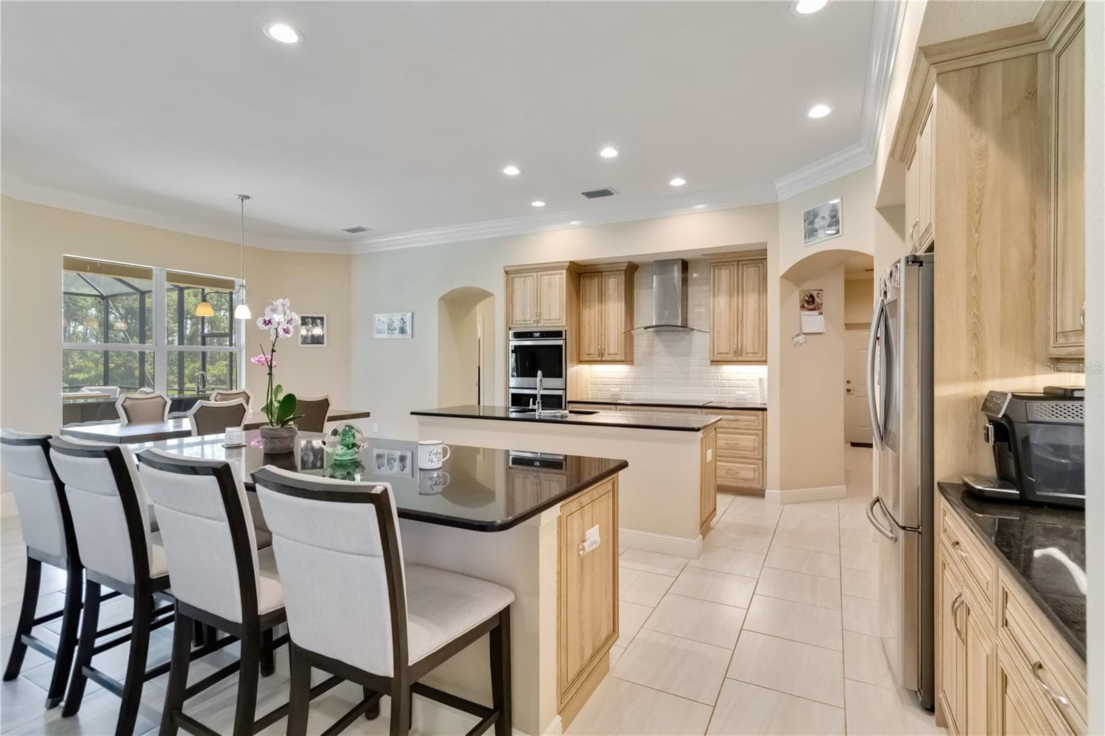 Large kitchen with double ovens, stainless steel appliances, granite counters and two islands. One island serves as an eating bar. The other island is great for cooking or meal prep and is the location of the sink. Under the double window is the eat-in kitchen space. - 1991 HEASLEY, ENGLEWOOD