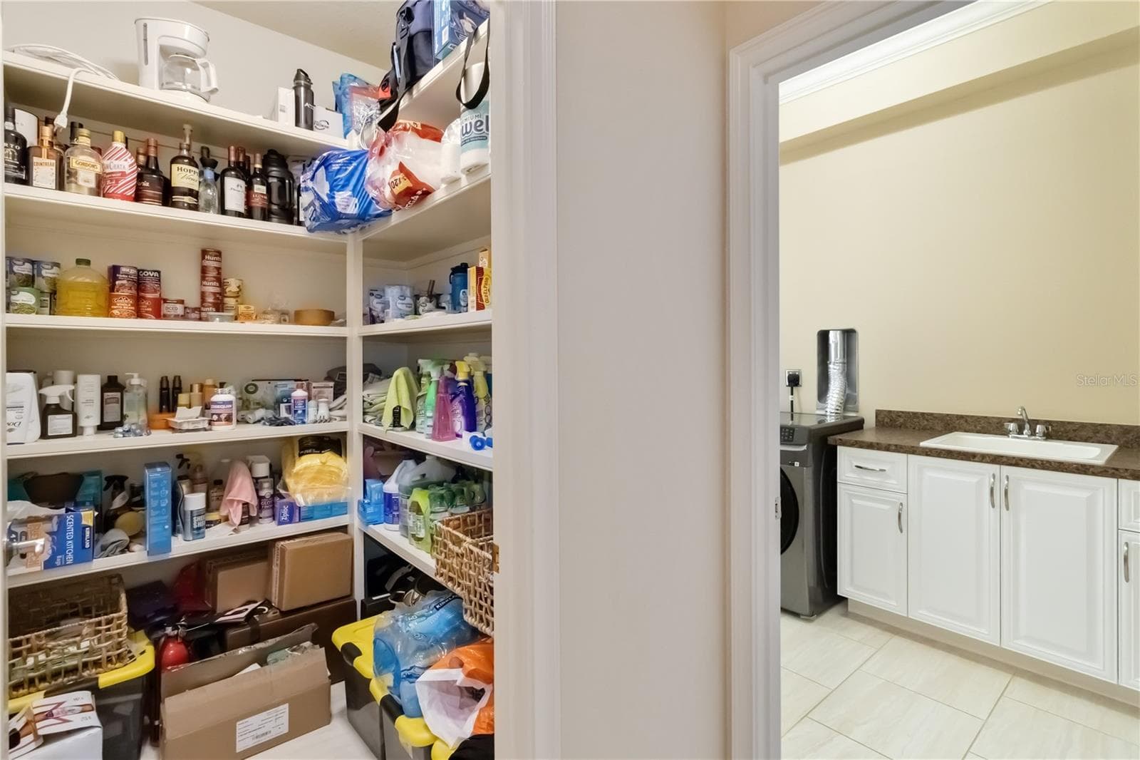 This walk-in pantry and laundry room are accessible through the arch in the previous picture of the kitchen. - 1991 HEASLEY, ENGLEWOOD
