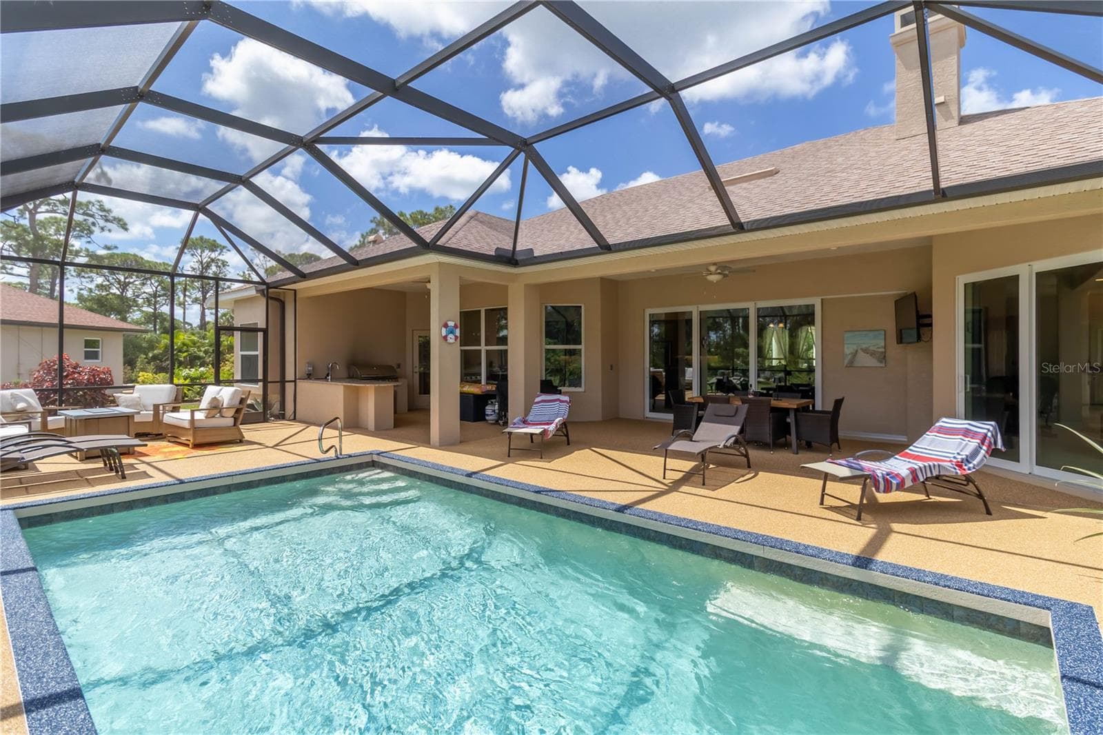The pool area! This is a heated, saltwater pool. Notice the huge sliders that lead into the great room. Opening those fully really brings the outside in. And whether they are open are closed, they bring in a lot of sunshine! - 1991 HEASLEY, ENGLEWOOD