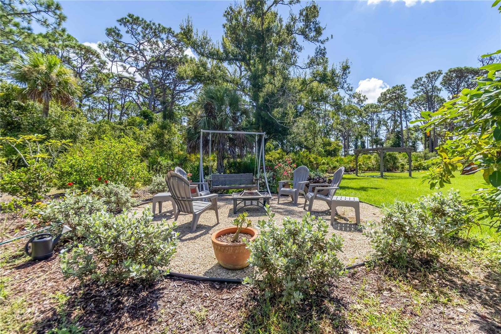 Another view of the fire pit.  Notice the wide open yard and pergola in the background. That is the perfect spot for a wedding (and yes, they had one there). - 1991 HEASLEY, ENGLEWOOD