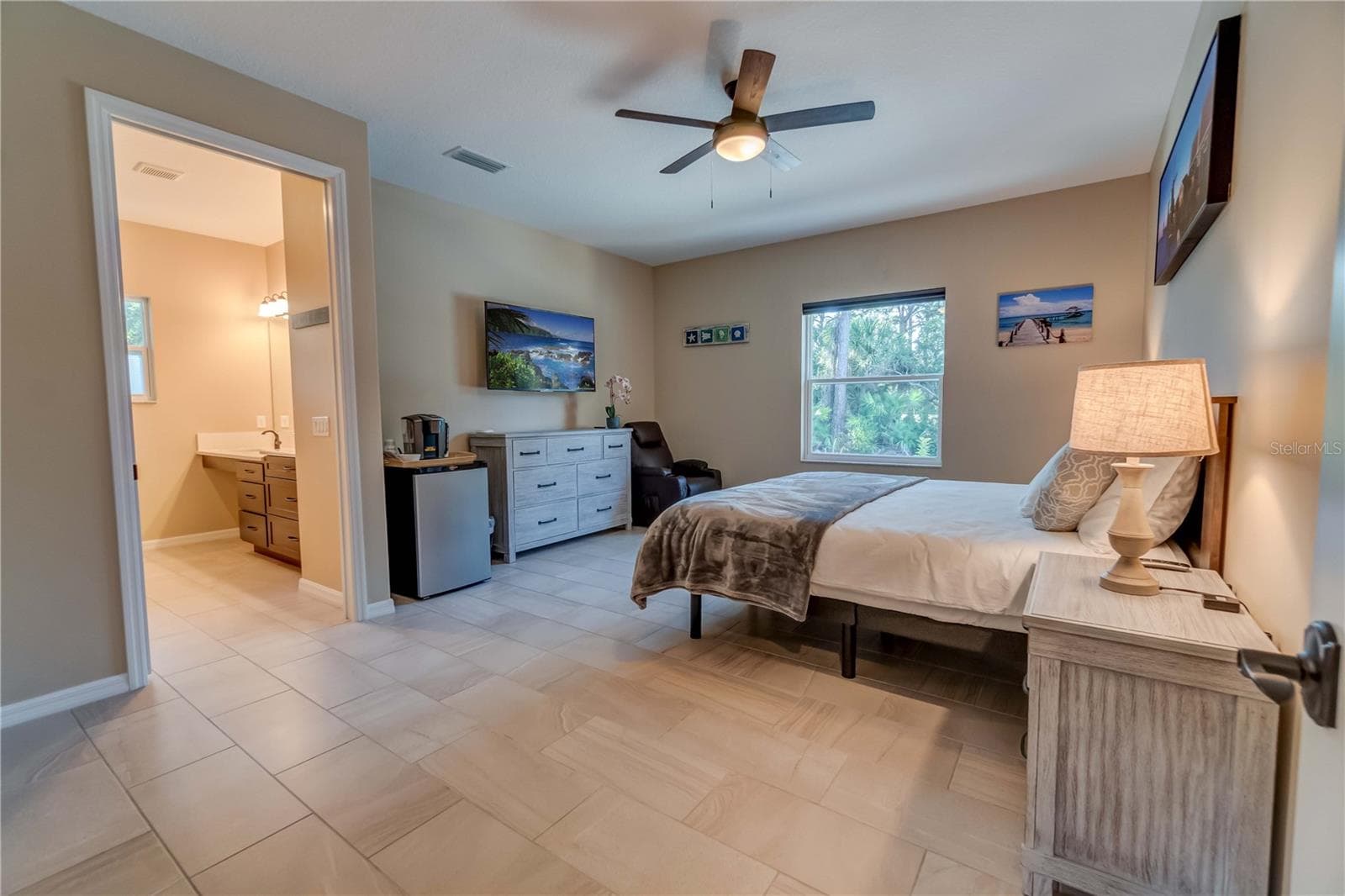 One of the guest room suites. Each suite is designed to have a small fridge as well as a TV. Because all 5 rooms are ADA compliant, the doors are extra wide and a pocket door separates the bedroom from the private bathroom. - 1991 HEASLEY, ENGLEWOOD