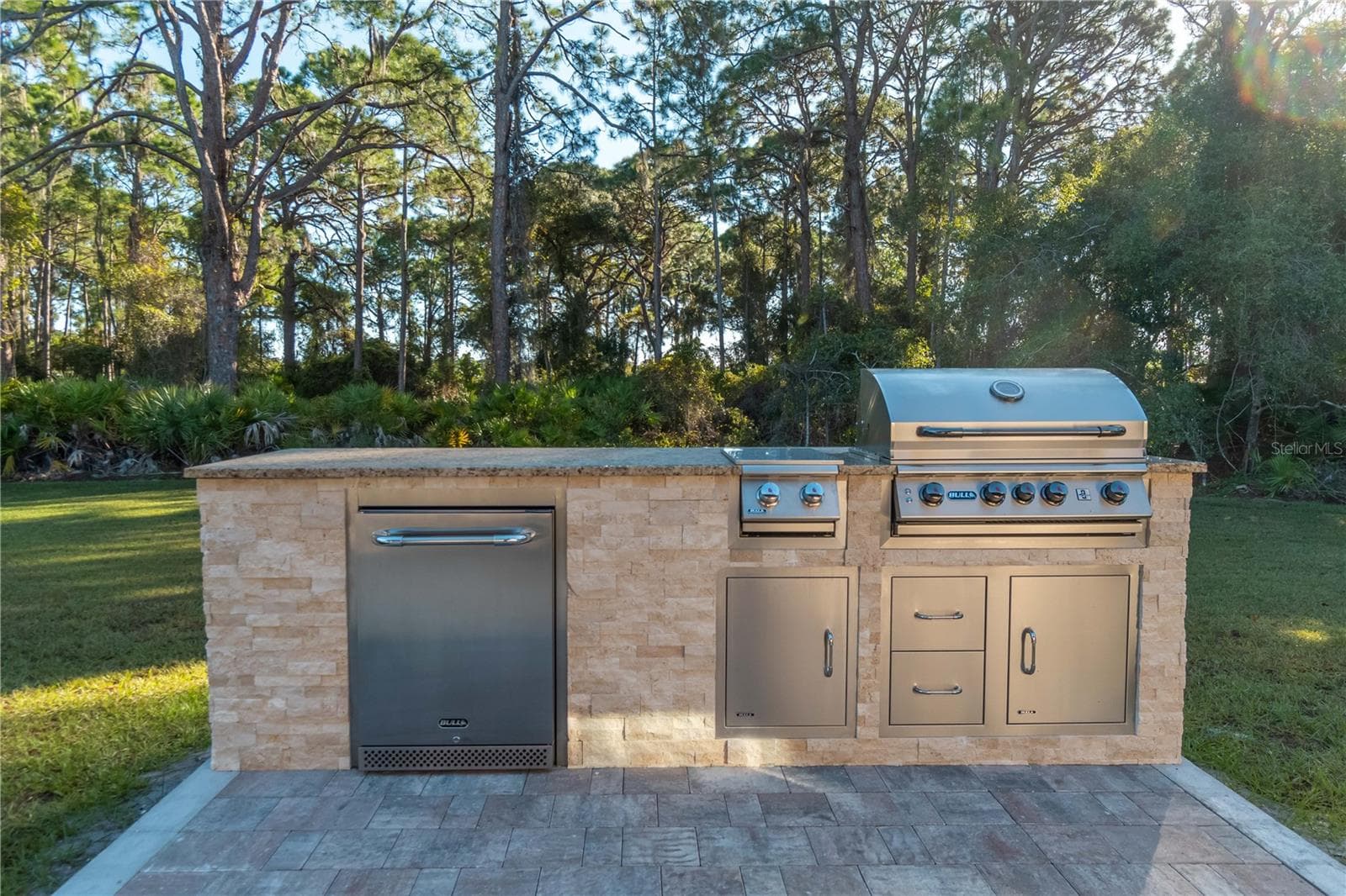 The outdoor kitchen by the guest house. It includes a grill, brumer, and a refrigerator. To the left is a covered pergola to enjoy your grilled dinner. - 1991 HEASLEY, ENGLEWOOD